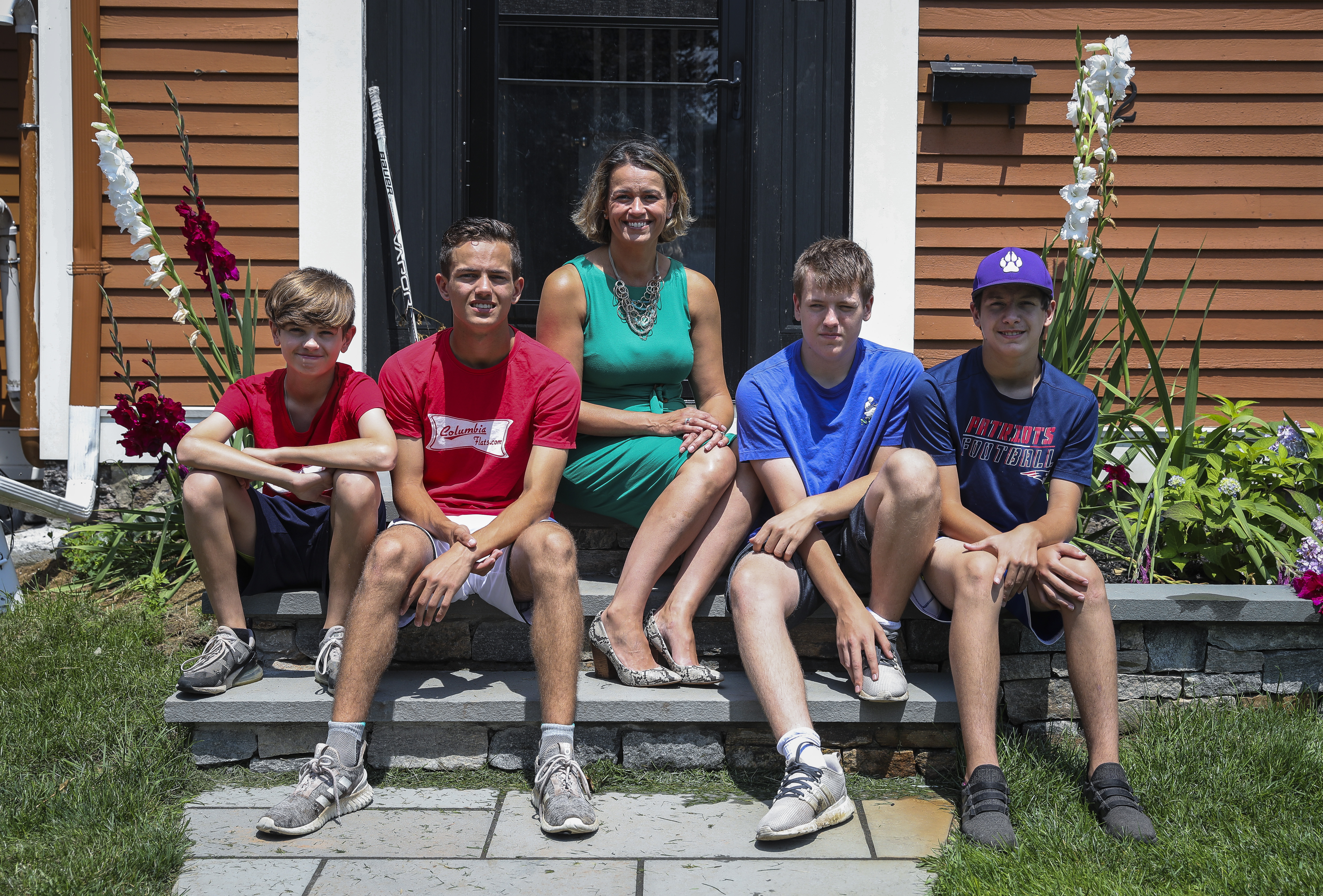 Mayoral candidate Annissa Essaibi George sat with her sons Samir, Douglas, Kayden, and Charlie on the fronts step of her Dorchester home.