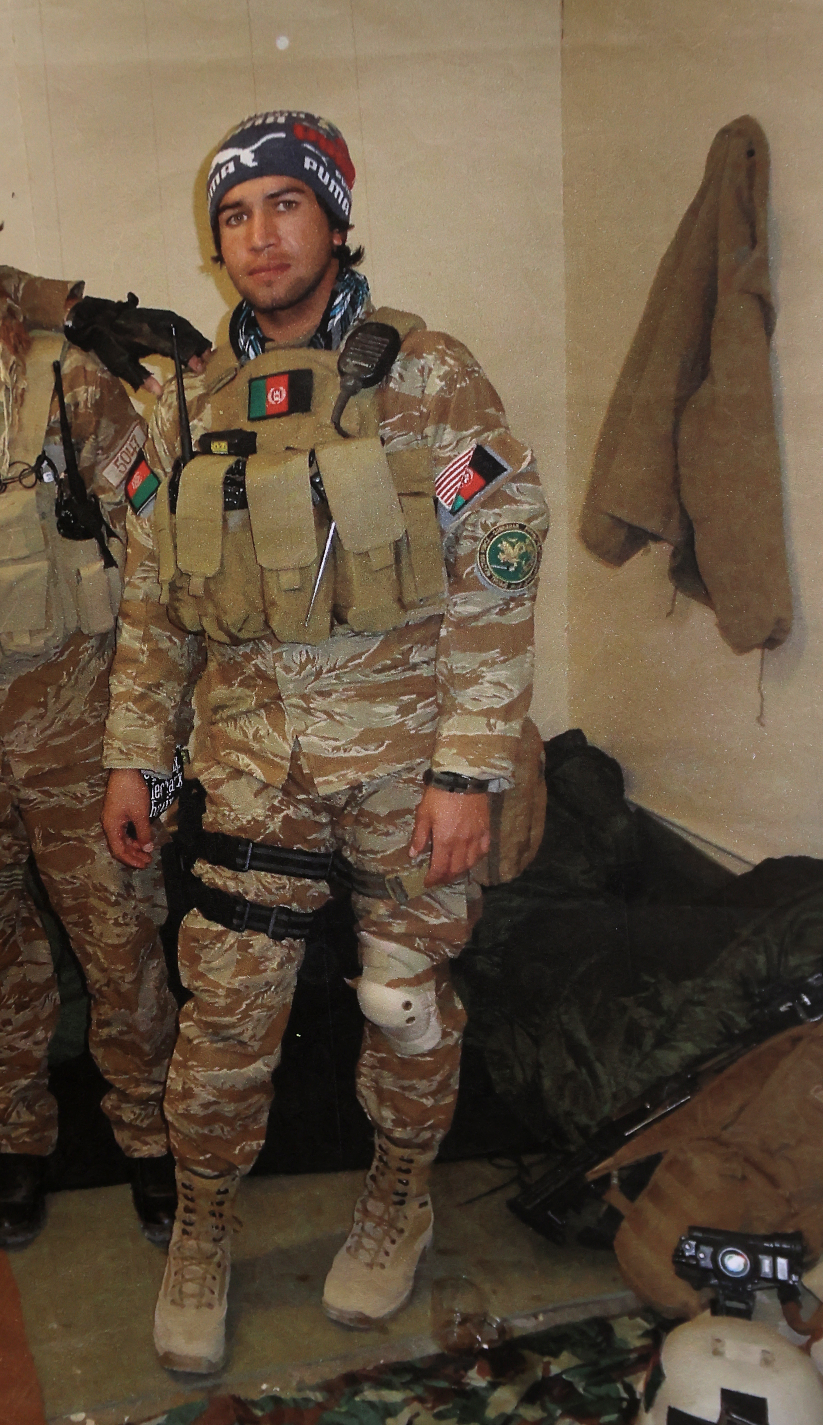 In a 2015 photograph, Aminullah Faqiry, an Afghan interpreter for the US military, wore his Special Unit uniform. He and his wife and four children are staying temporarily with a host family in Providence.