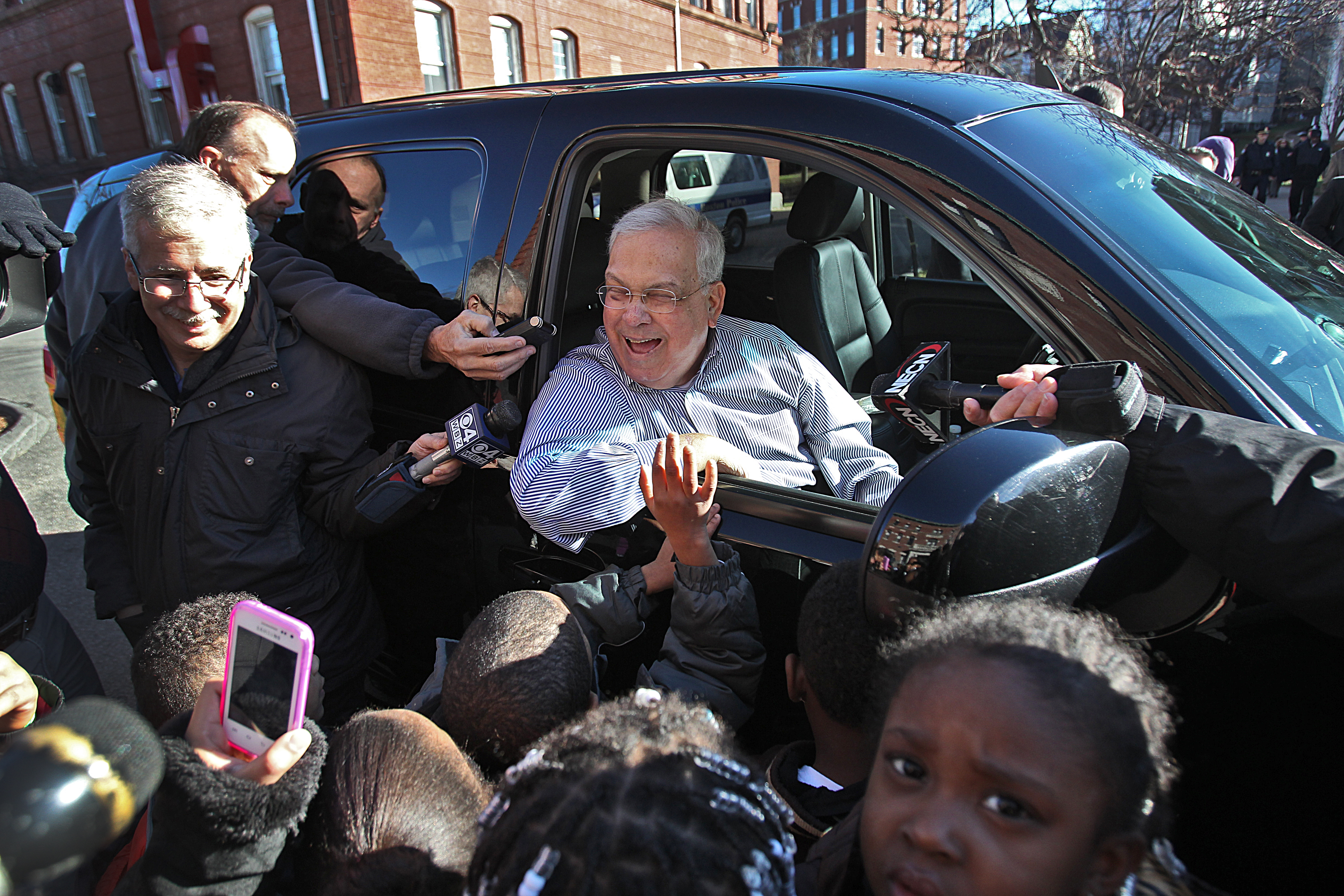 Boston Mayor Thomas Menino greeted children getting gifts at the Catholic Charities Teen Center at St. Peter's on Dec. 24, 2012.