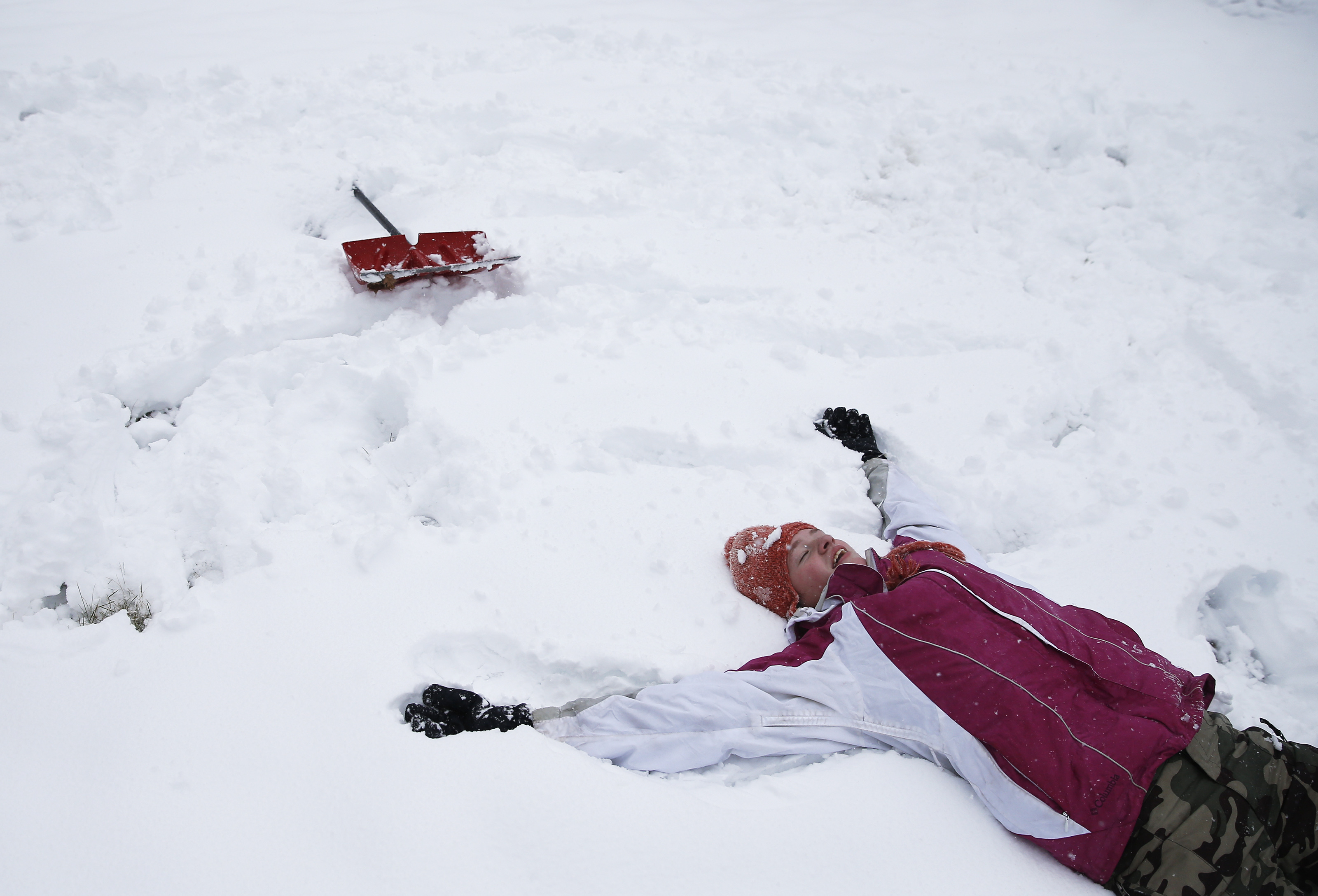 Maddie Alexander, age 14, collapsed in the snow after a snowball fight with her two brothers in Wilmington on Dec. 2, as they enjoyed the first snowstorm of the winter.