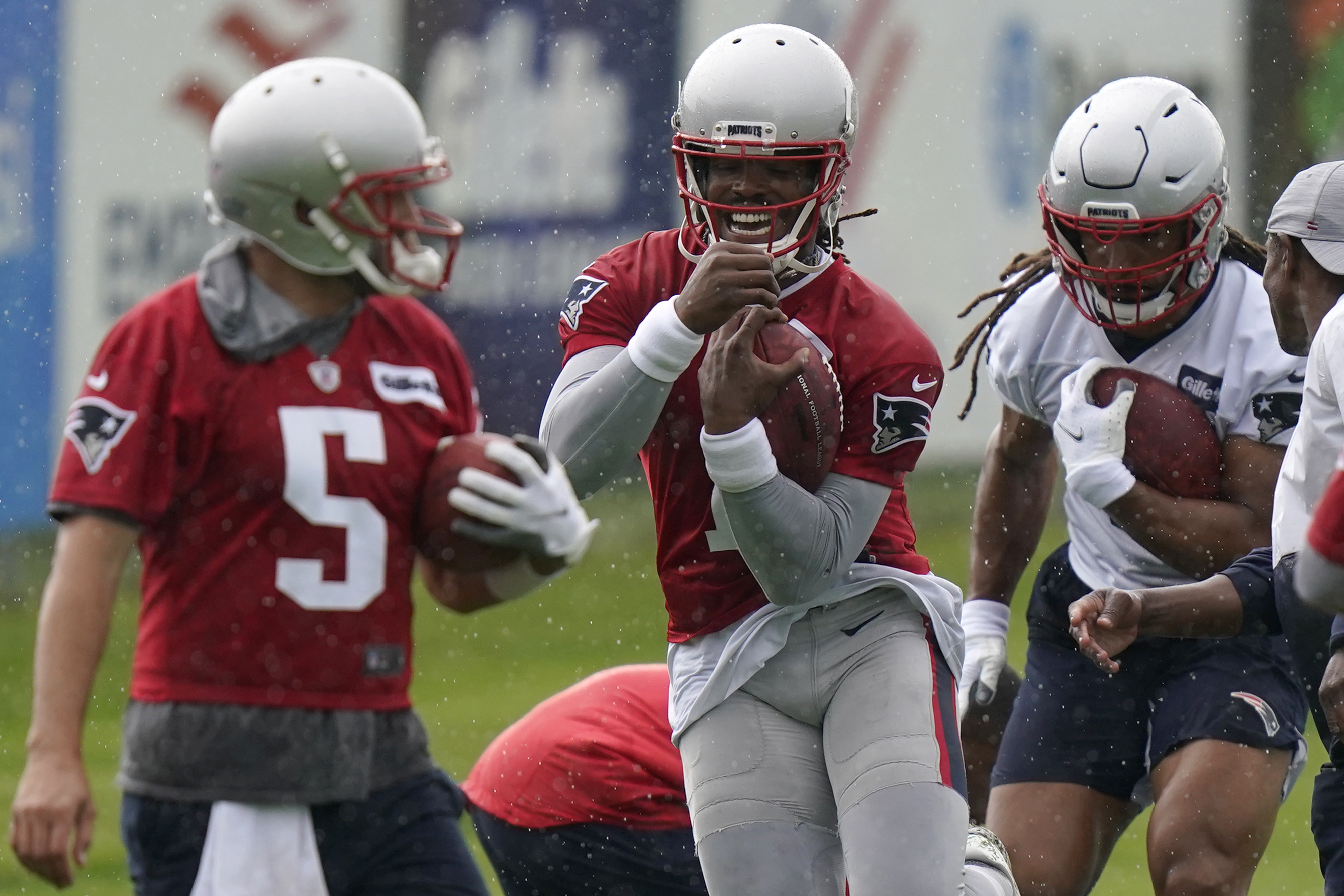 Brian Hoyer, Cam Newton and tight end Jakob Johnson go through drills Monday in Foxborough.