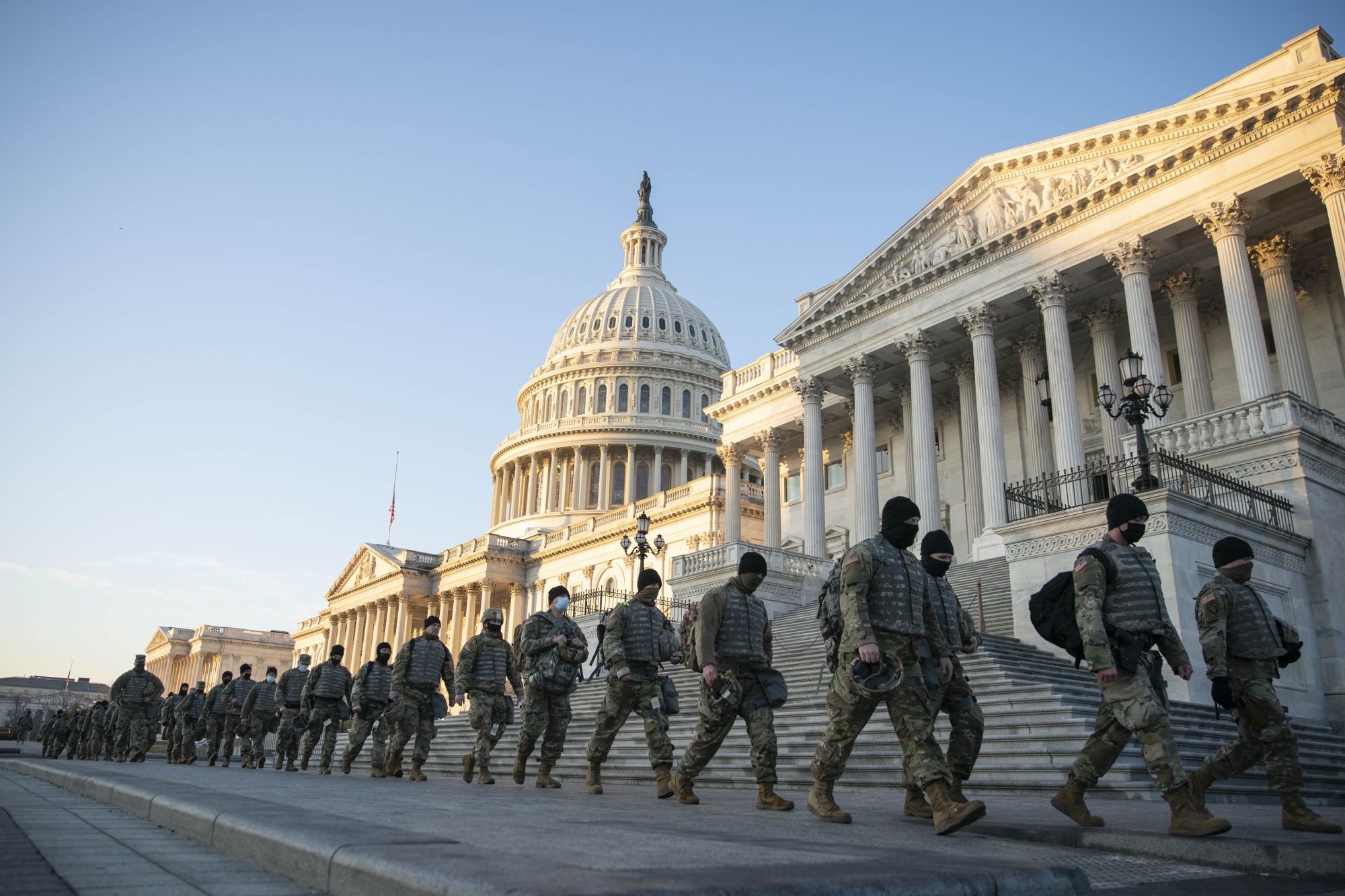 Members of the National Guard walked outside of the US Capitol.
