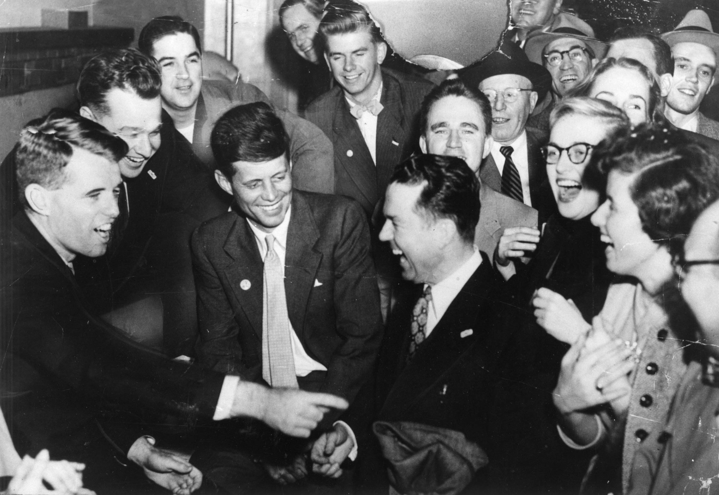 Senator John F. Kennedy (middle, foreground) the day after he beat Henry Cabot Lodge. Campaign manager Bobby Kennedy is at left.