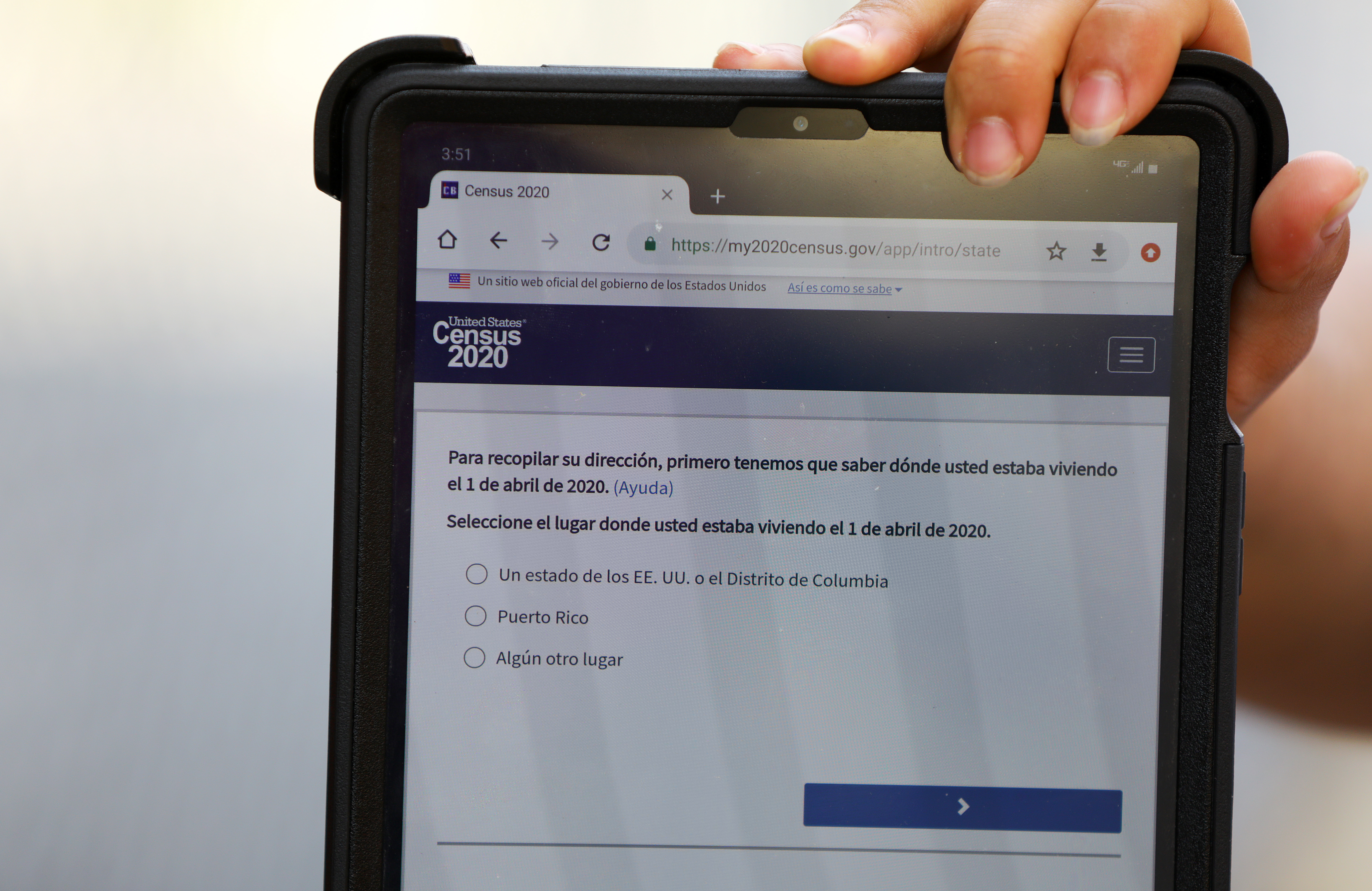 Census 2020 field organizers use tablets as they interview people in the food pantry line at the Chelsea Collaborative to attempt to get an accurate count during the coronavirus pandemic.