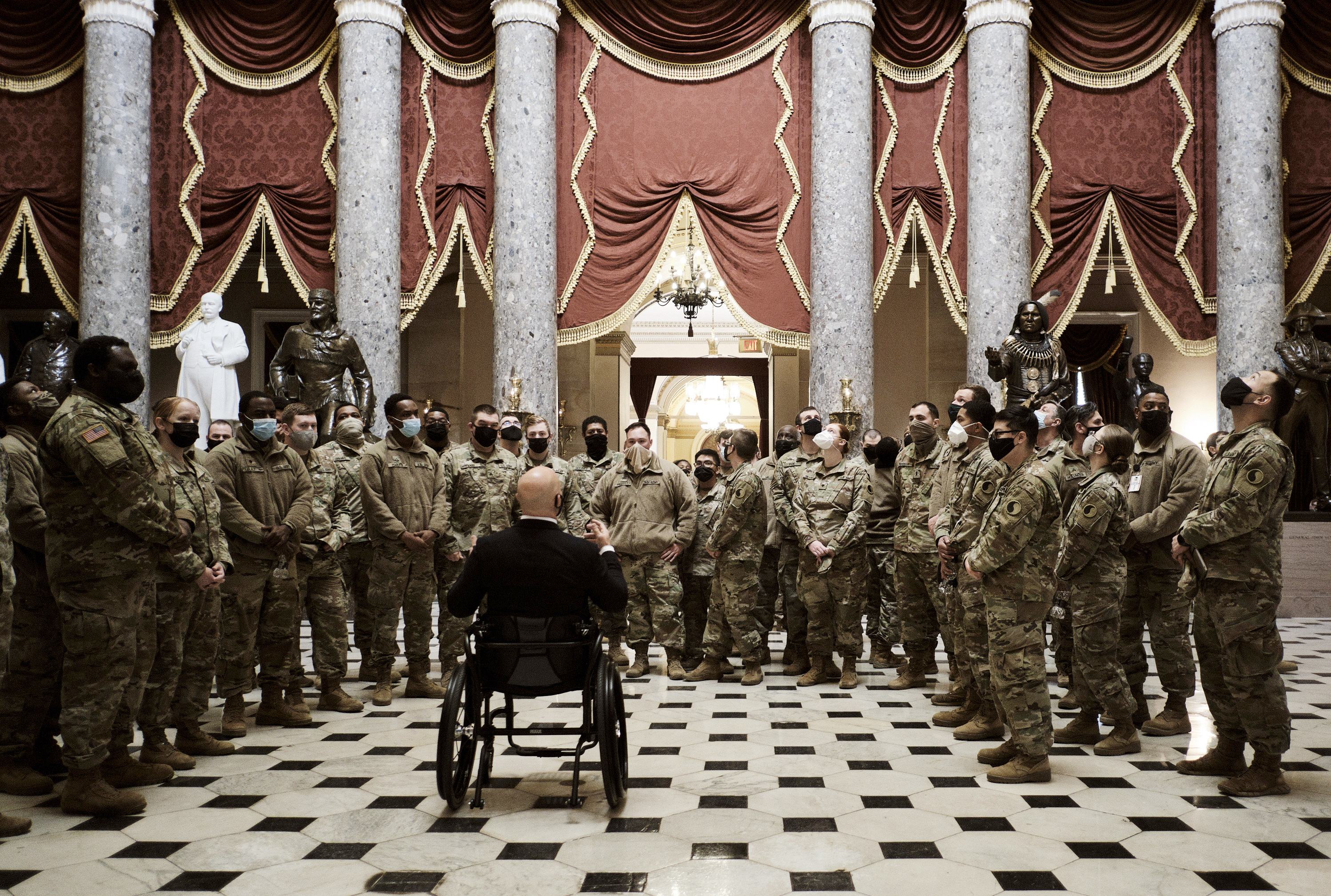 Rep. Brian Mast (R-Fla.) lead a tour for a group of Virginia National Guard troops through Statuary Hall at the US Capitol.
