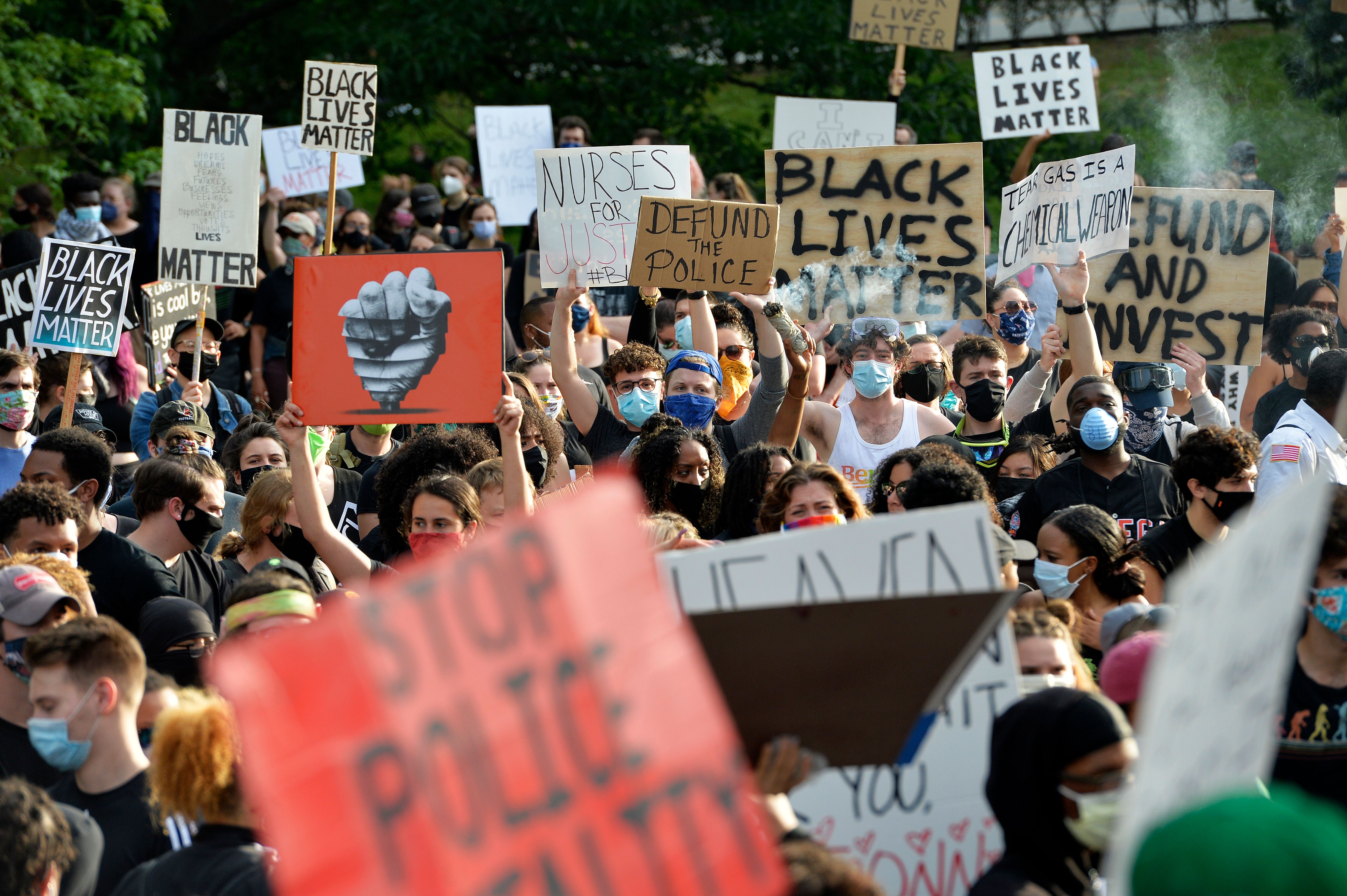 Protesters rally on the steps of the State House, calling for an end to Police injustice, in Providence on June 5, 2020.