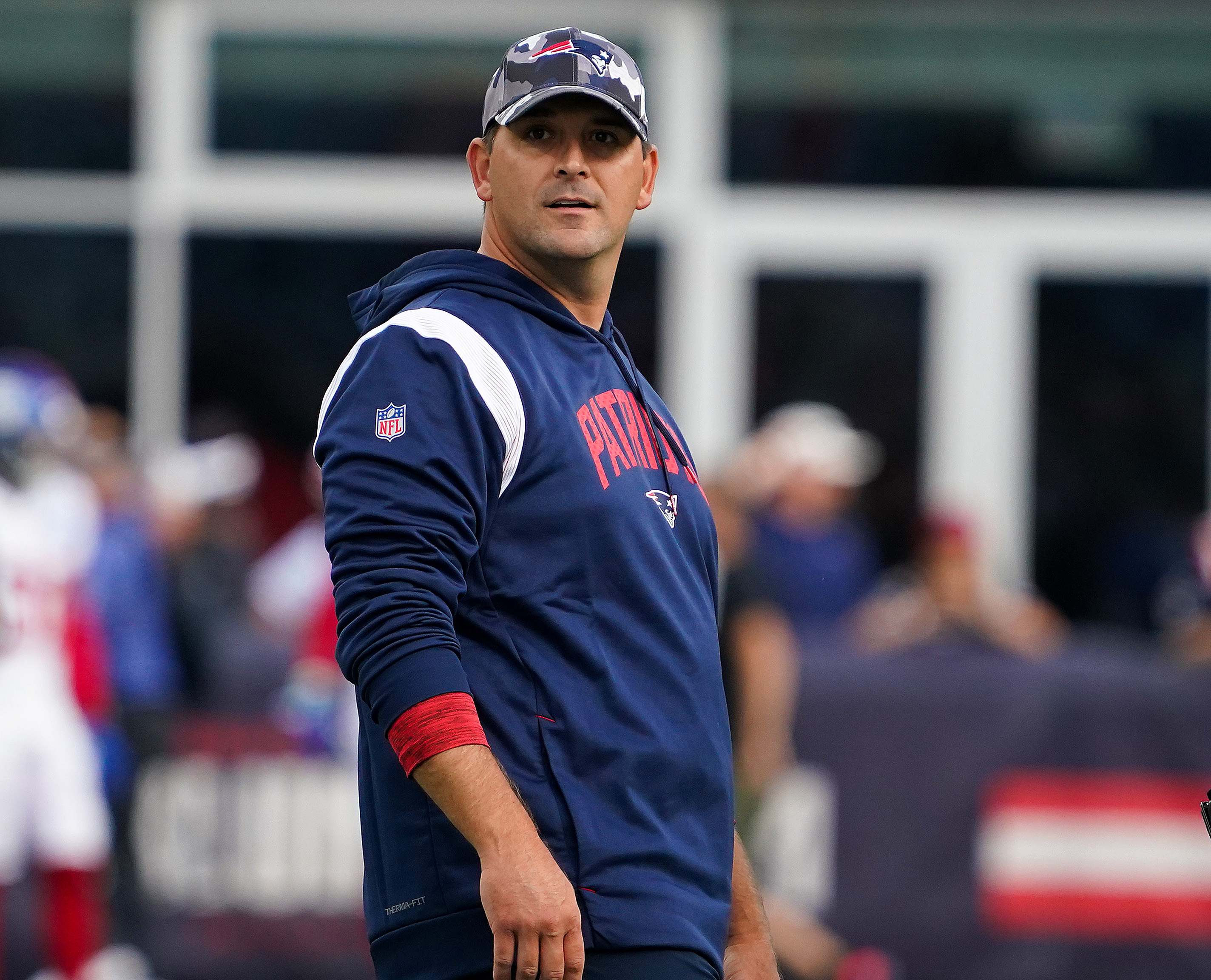 New England Patriots assistant coach Matt Patricia makes a play call on the  sideline while wearing in Italian flag on his shirt during the first half  of an NFL football game against