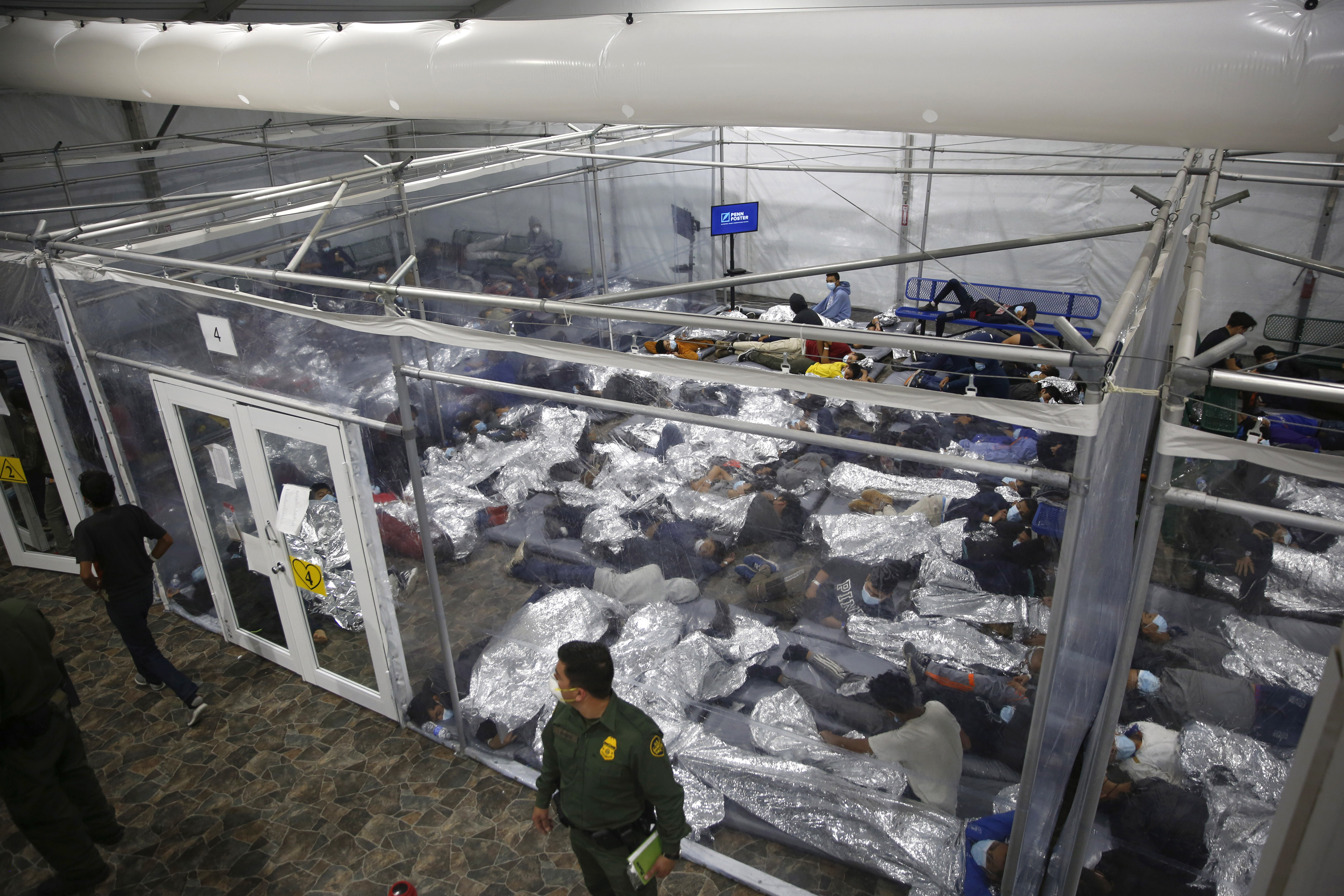 Young minors lay inside a pod at the Donna Department of Homeland Security holding facility, the main detention center for unaccompanied children in the Rio Grande Valley run by US Customs and Border Protection in Donna, Texas, on March 30.