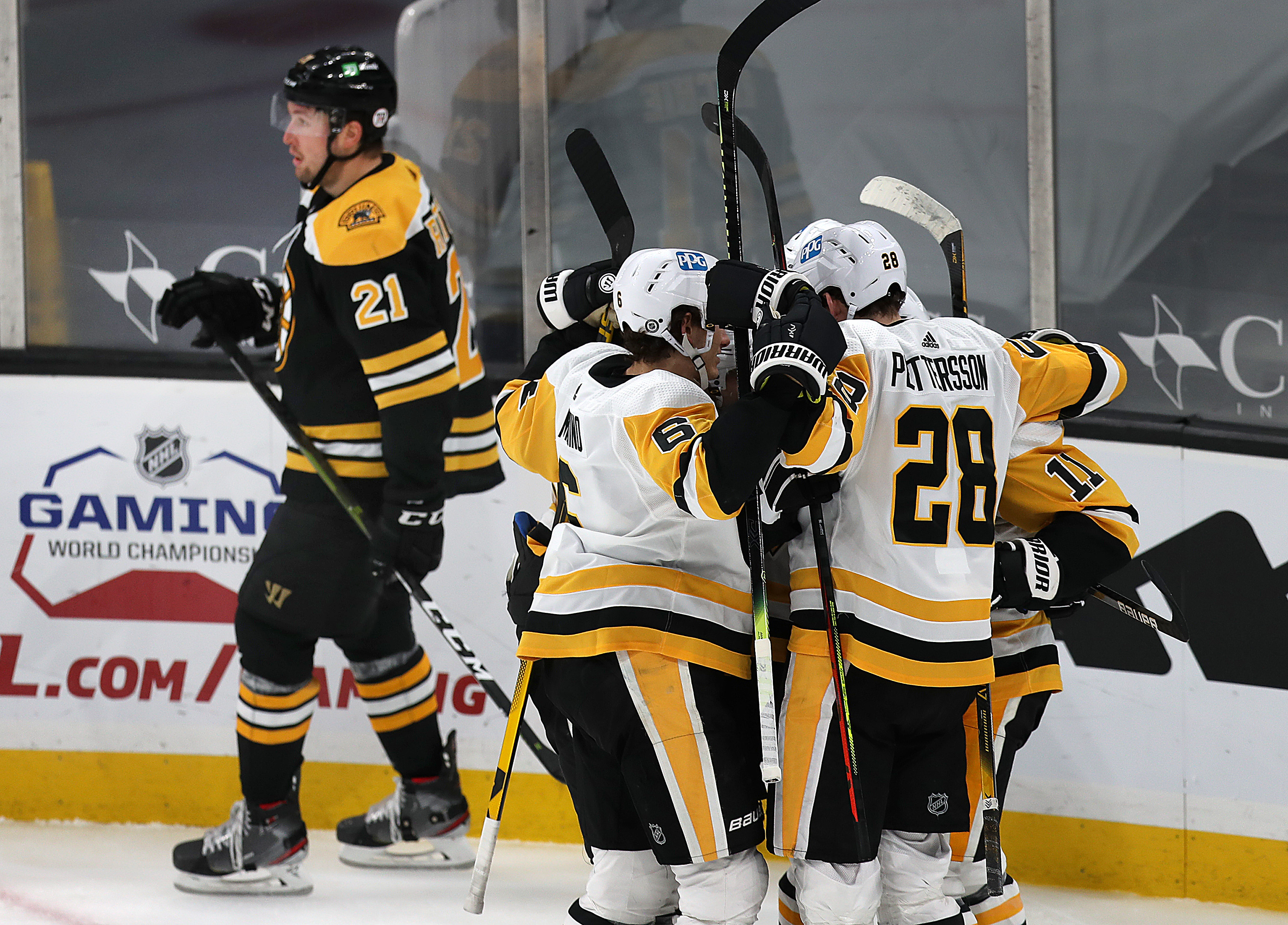 Nick Ritchie (21) skates by as the Penguins celebrate a second-period goal from Zach Aston-Reese.