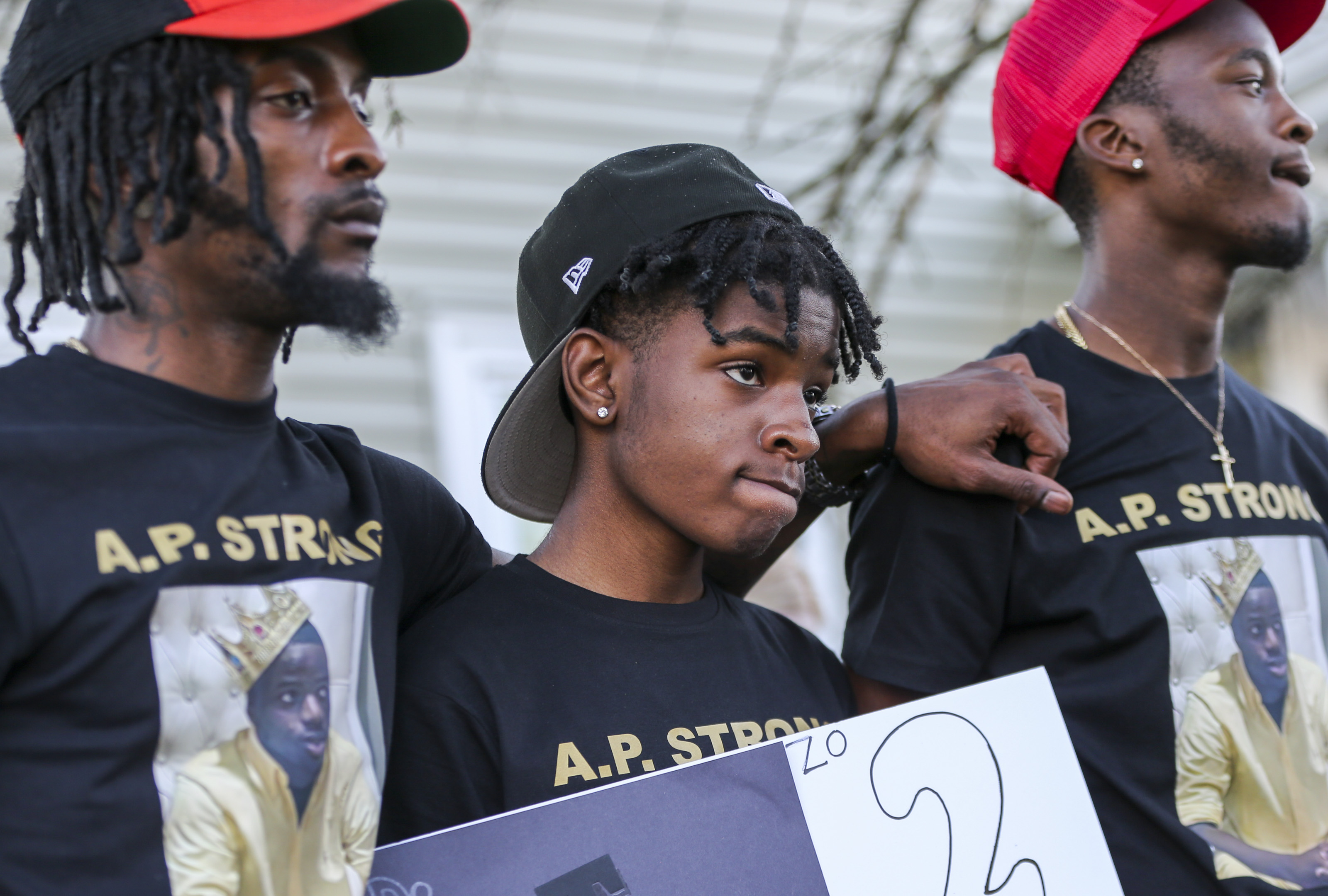 Alonzo Polk's family prayed during the vigil outside his home.
