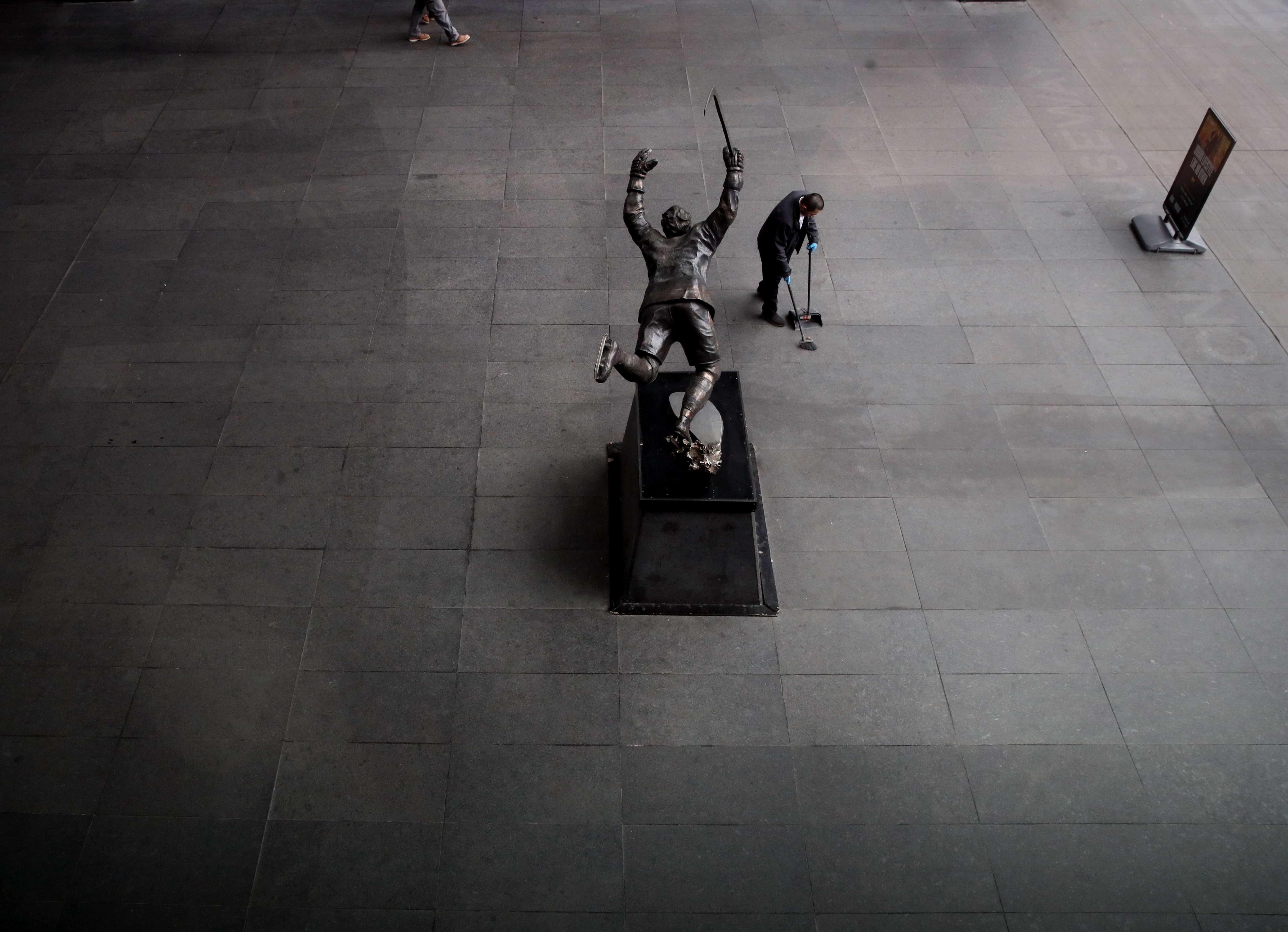 Boston,MA - 3/12/2020: A man cleans near the Bobby Orr Statue outside the TD Garden in Boston, MA  on March 12, 2020. 
The NHL announced Thursday that it was pausing its 2019-20 season in response to the coronavirus outbreak.
It becomes the third North America pro league to suspend games, following the NBA’s decision on Wednesday night and MLS’s announcement Thursday.(Craig F. Walker/Globe Staff)