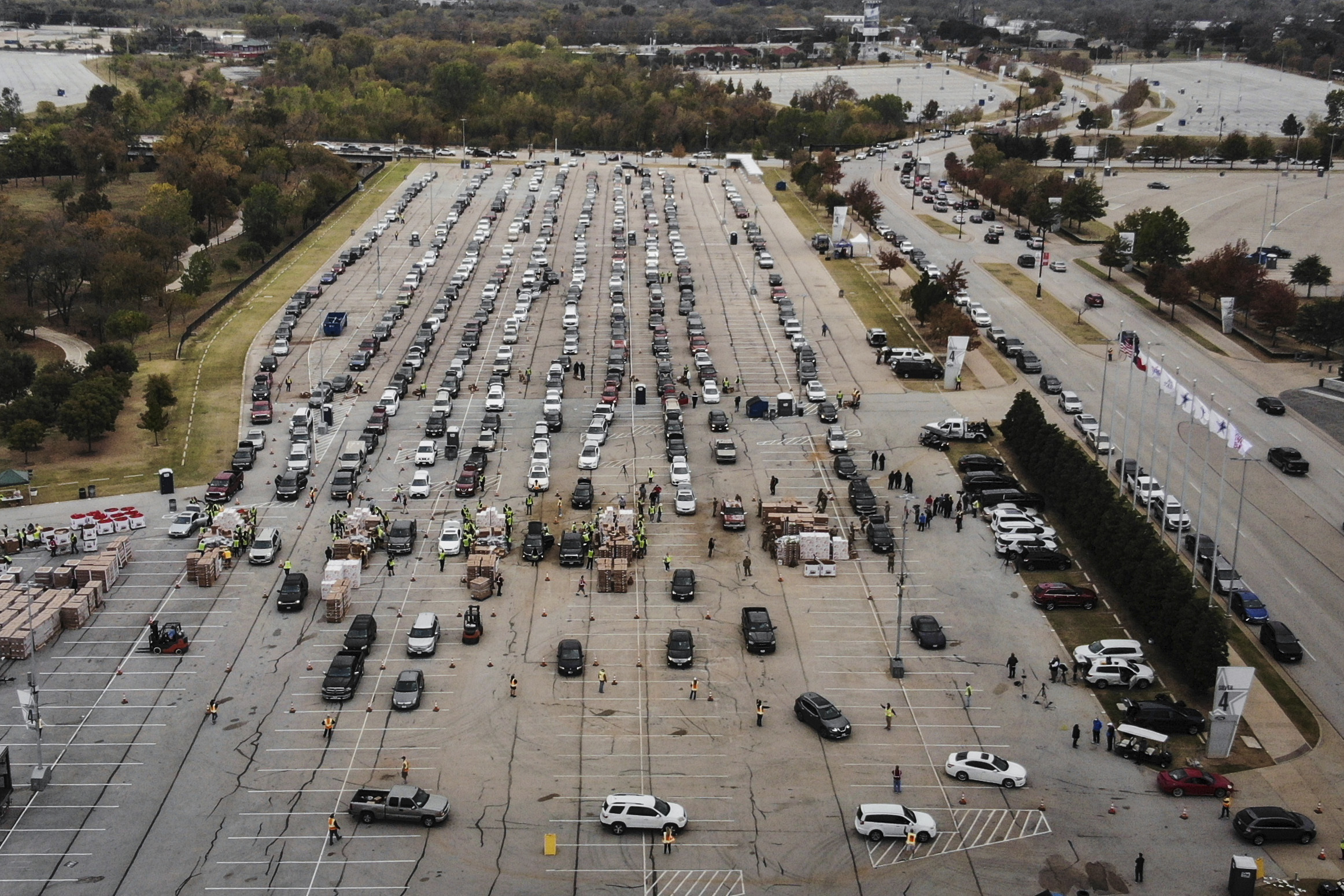 People lined up in their cars to receive Thanksgiving meal boxes that included turkey and pantry items from the Tarrant Area Food Bank, Nov. 20, in the AT&T Stadium parking lot, in Arlington, Texas. The food giveaway, to help people during the COVID-19 pandemic and the holidays, was the largest in the organization's history.