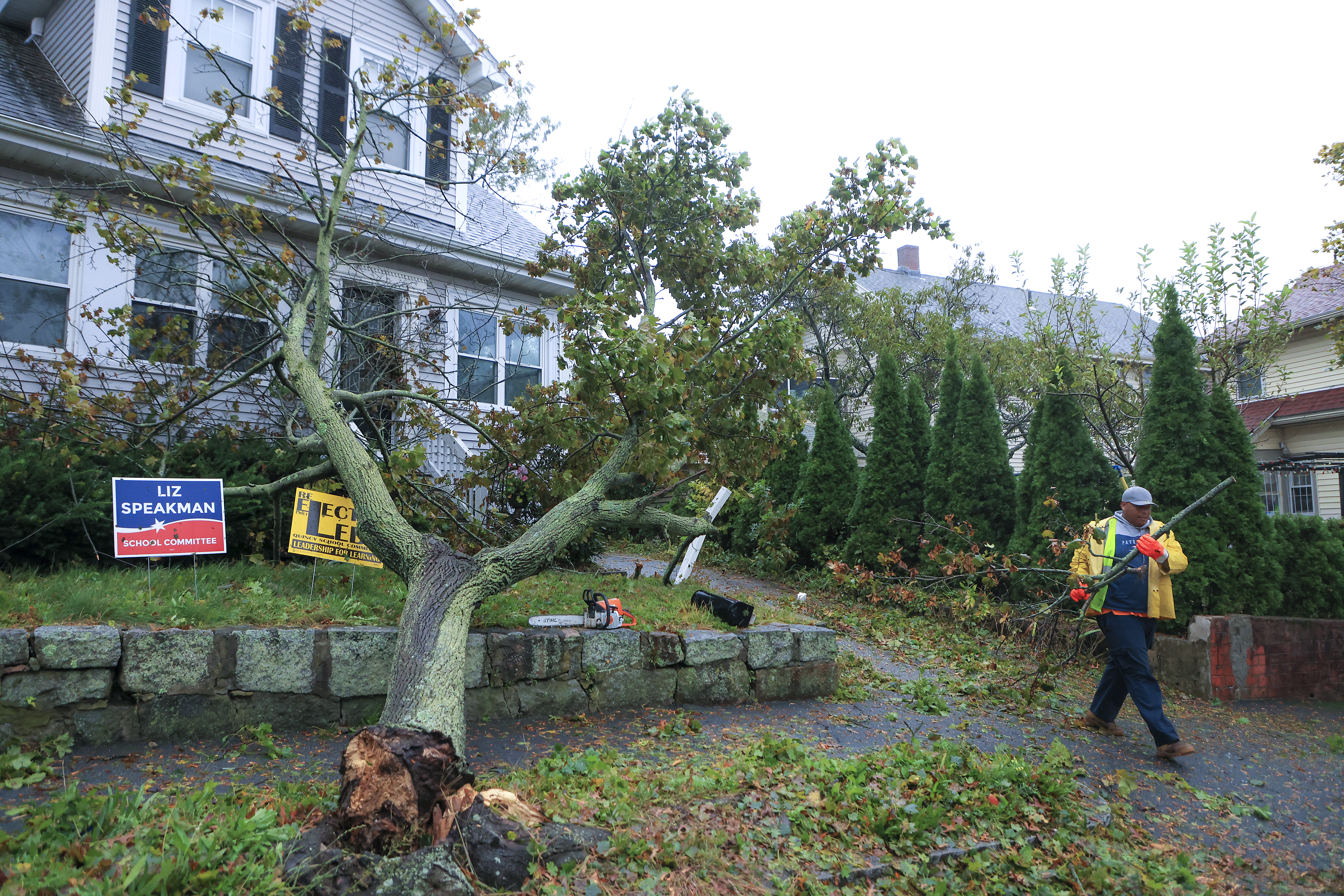 A Quincy Public Works employee removed debris from a fallen tree at a house on Bailey Street on Wednesday caused by the powerful nor'easter’s wind gusts topping 90 mph.