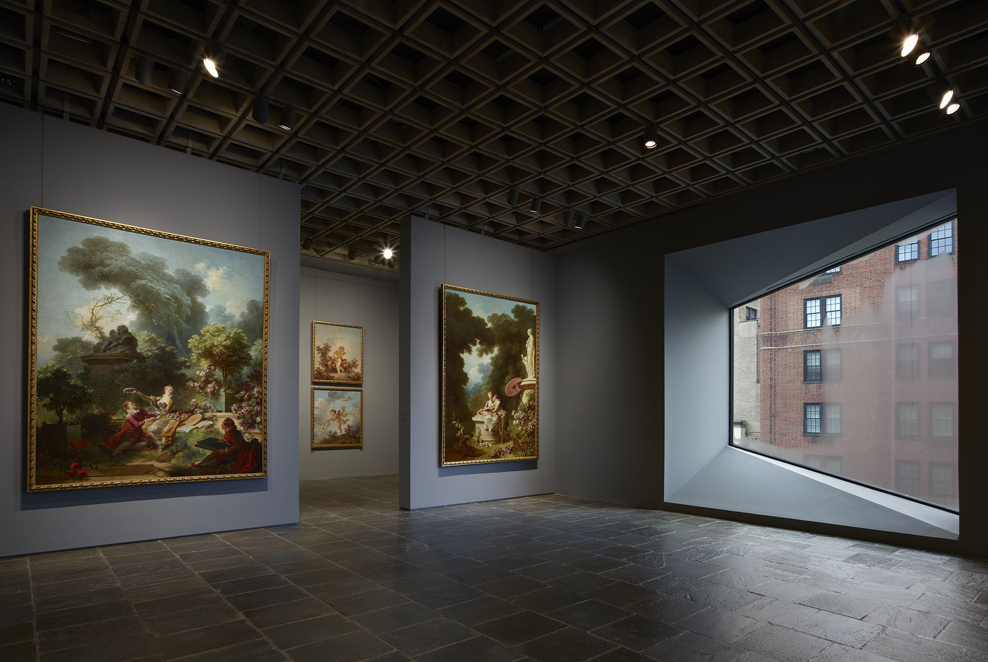Panels from Fragonard’s "The Progress of Love" series (1771-72) are displayed together at the Frick Madison, illuminated by one of Marcel Breuer’s trapezoidal windows.