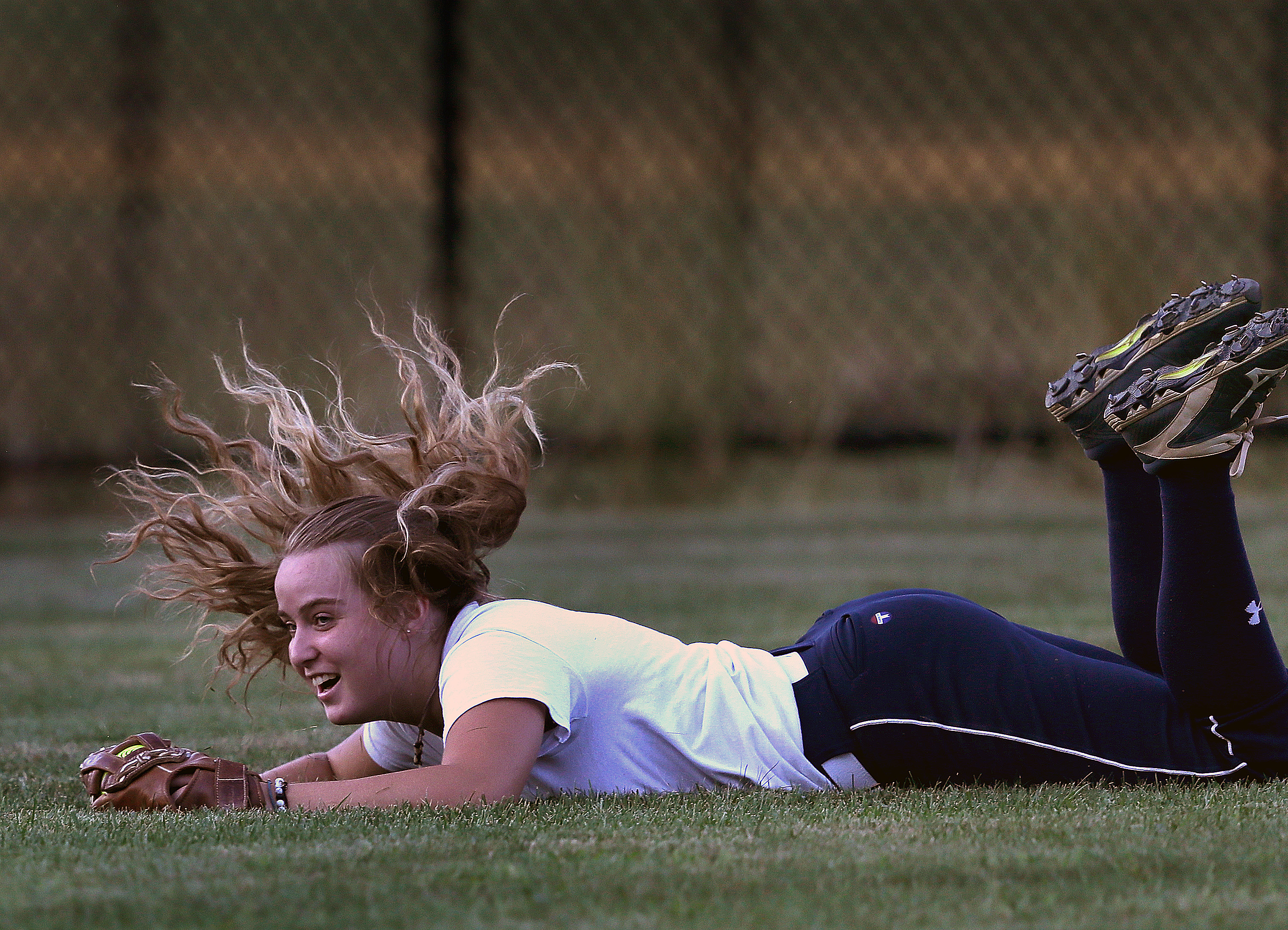 . . . and with the ball tucked away in her glove at Forges Field, was all smiles after taking away a run.