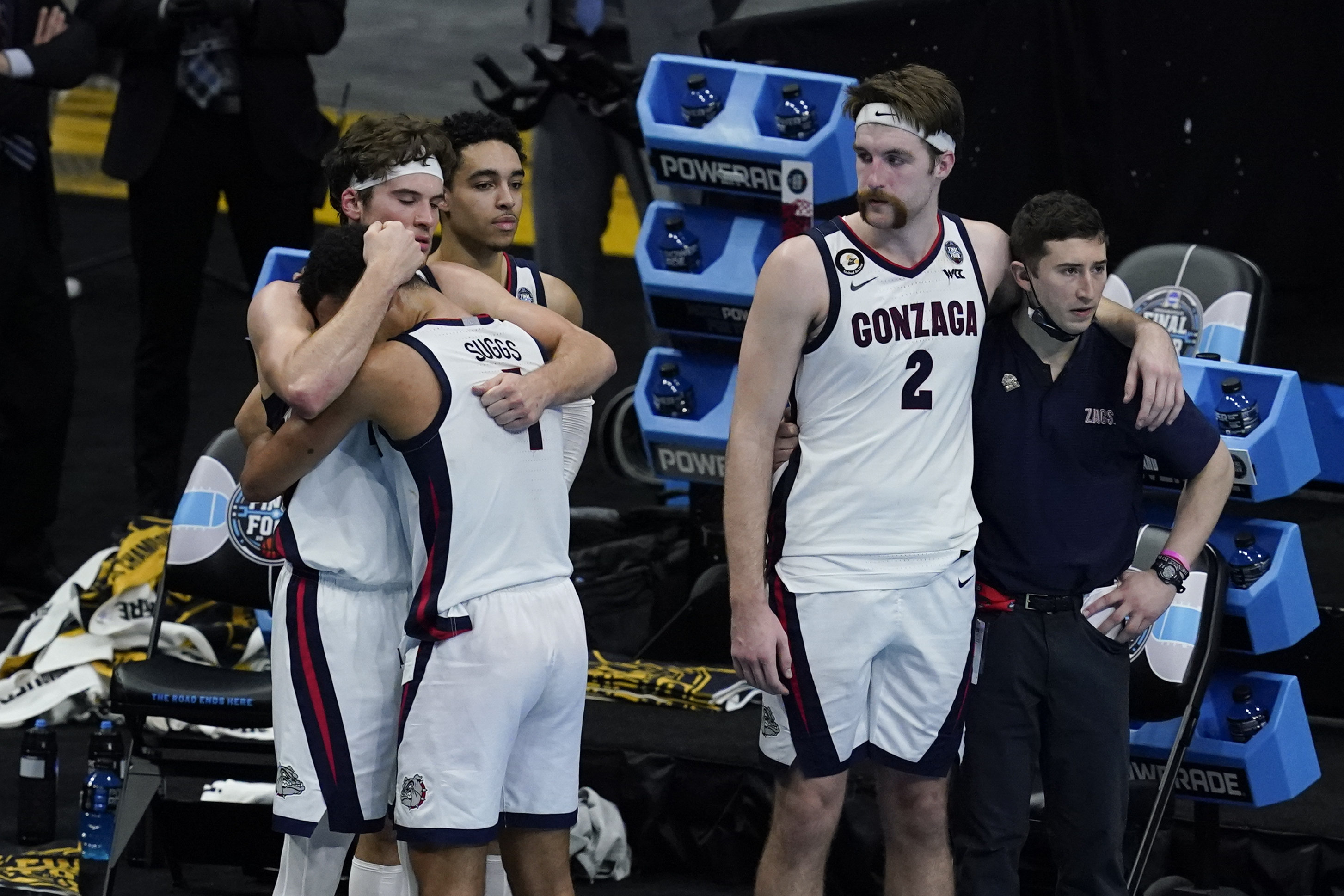 Gonzaga's Corey Kispert hugs Jalen Suggs as Drew Timme looks on at the end of the championship game against Baylor Monday night.