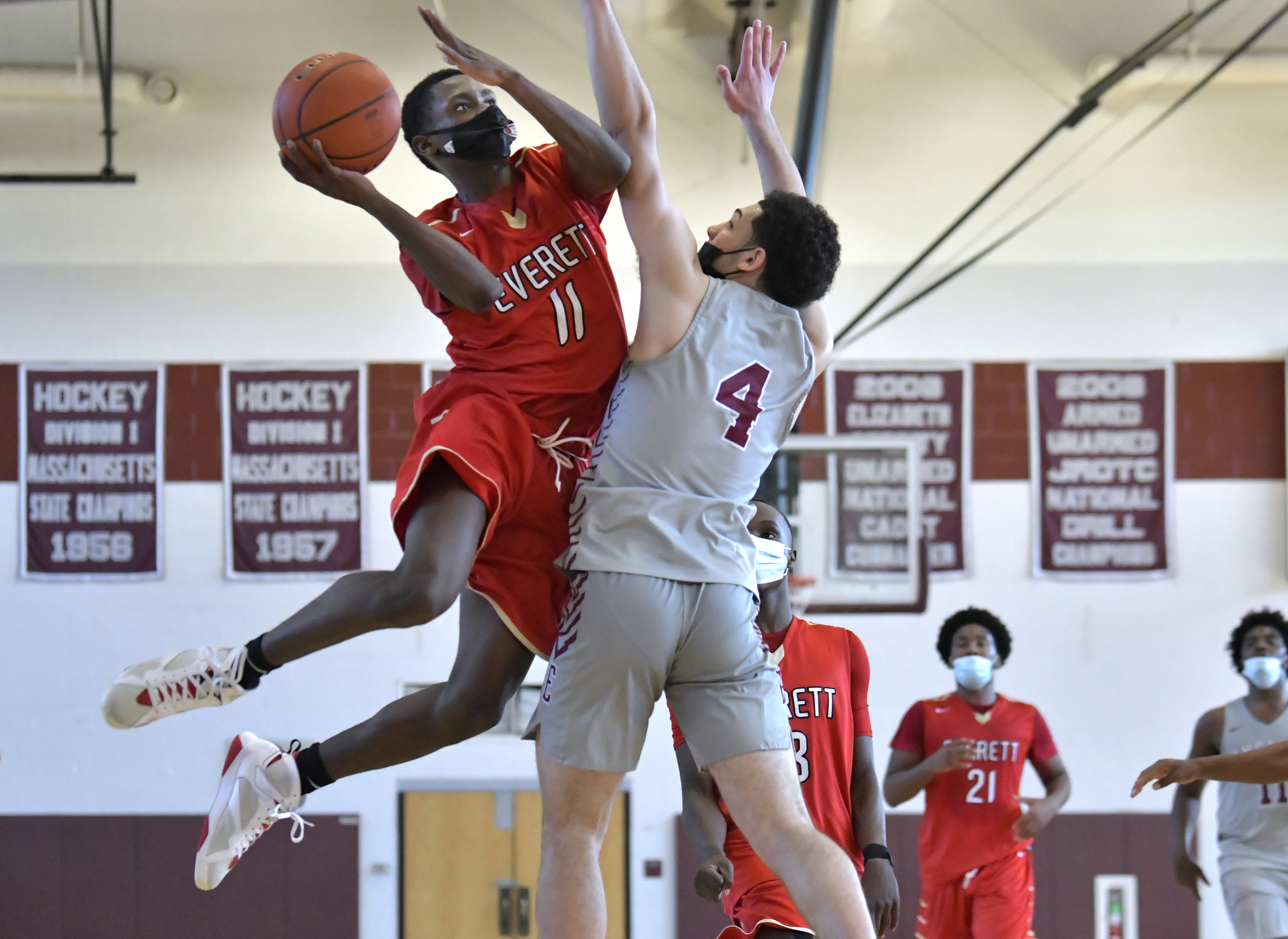 Everett's John Monexant (11) soars to the basket Louis Rivera (4) of Lynn English in Saturday's Greater Boston League championship game.