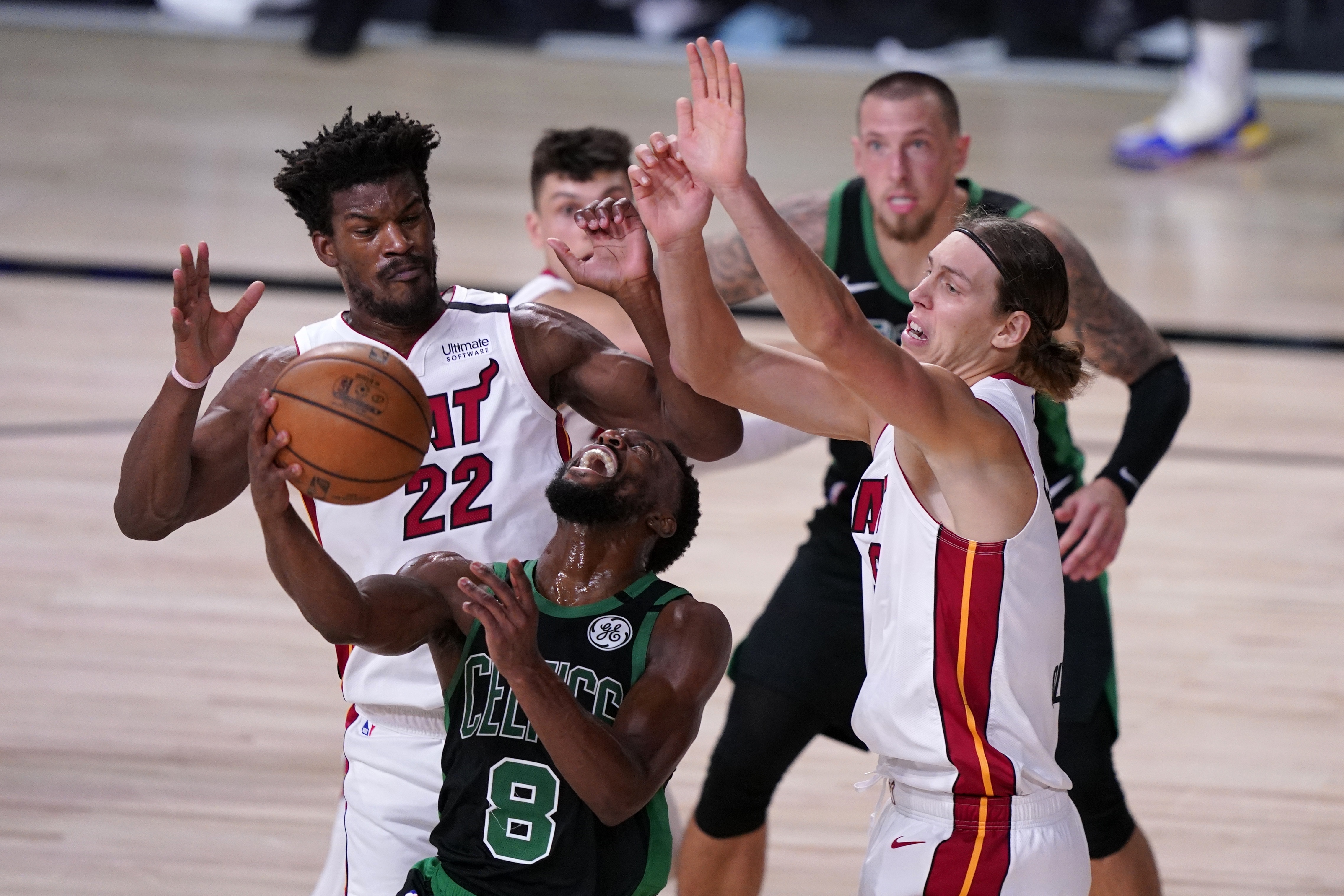 Kemba Walker finds his path to the rim blocked by Miami's Jimmy Butler and Kelly Olynyk Thursday night.