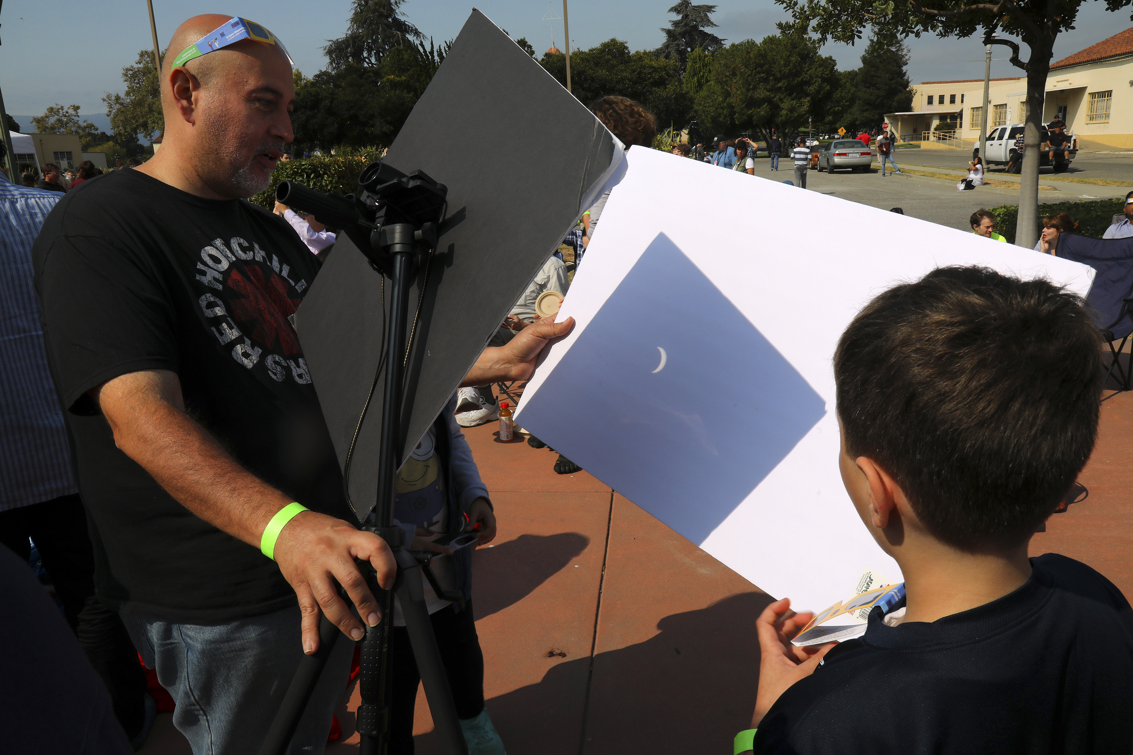 Ki Siadatan and his son Cyrus viewed the solar eclipse through a pinhole camera that Cyrus created, at NASA Ames Research Center, in Mountain View, Calif., Aug. 21, 2017.