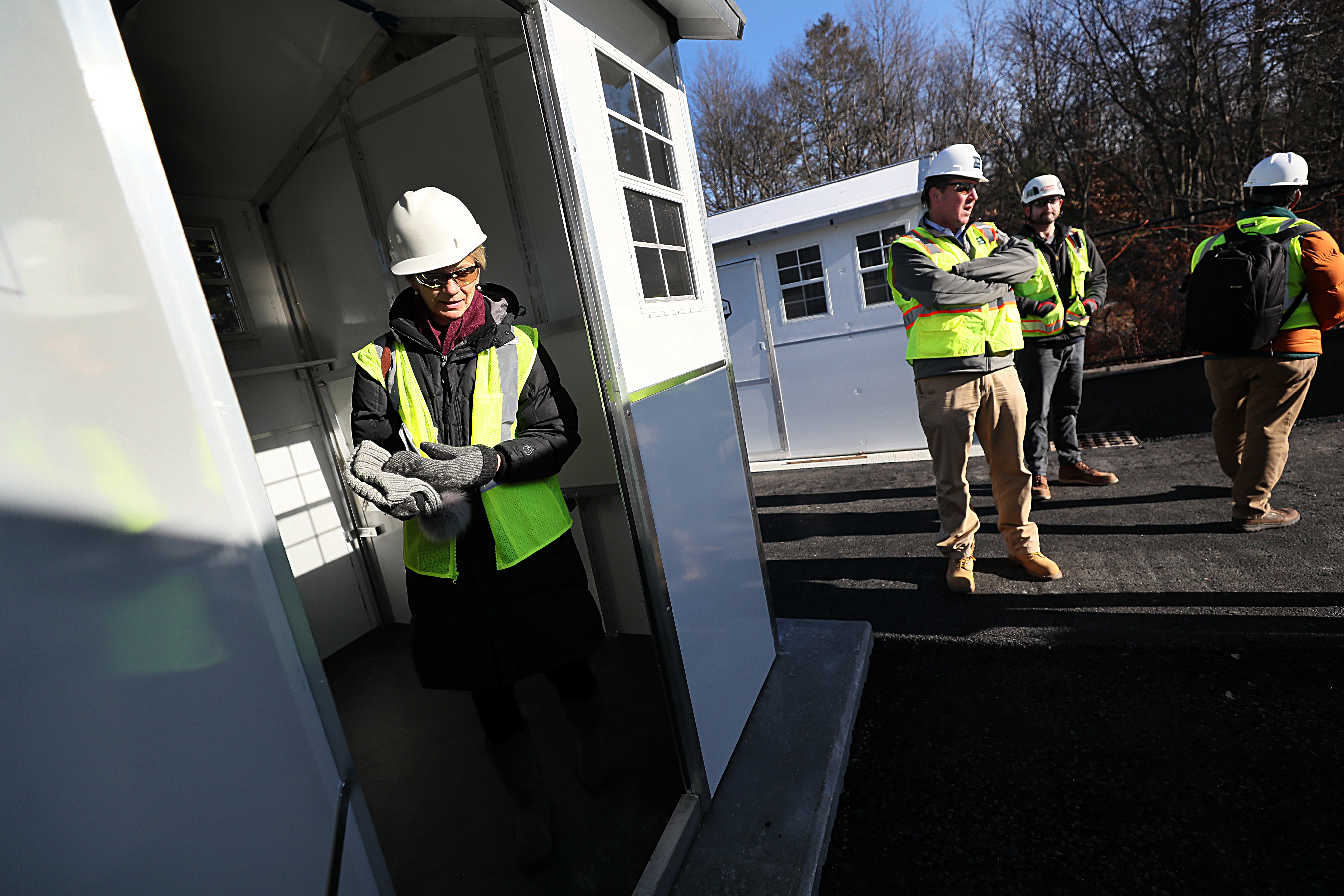 Massachusetts Secretary of Health and Human Services Marylou Sudders (left) and other state officials surveyed a 30-unit cottage community.