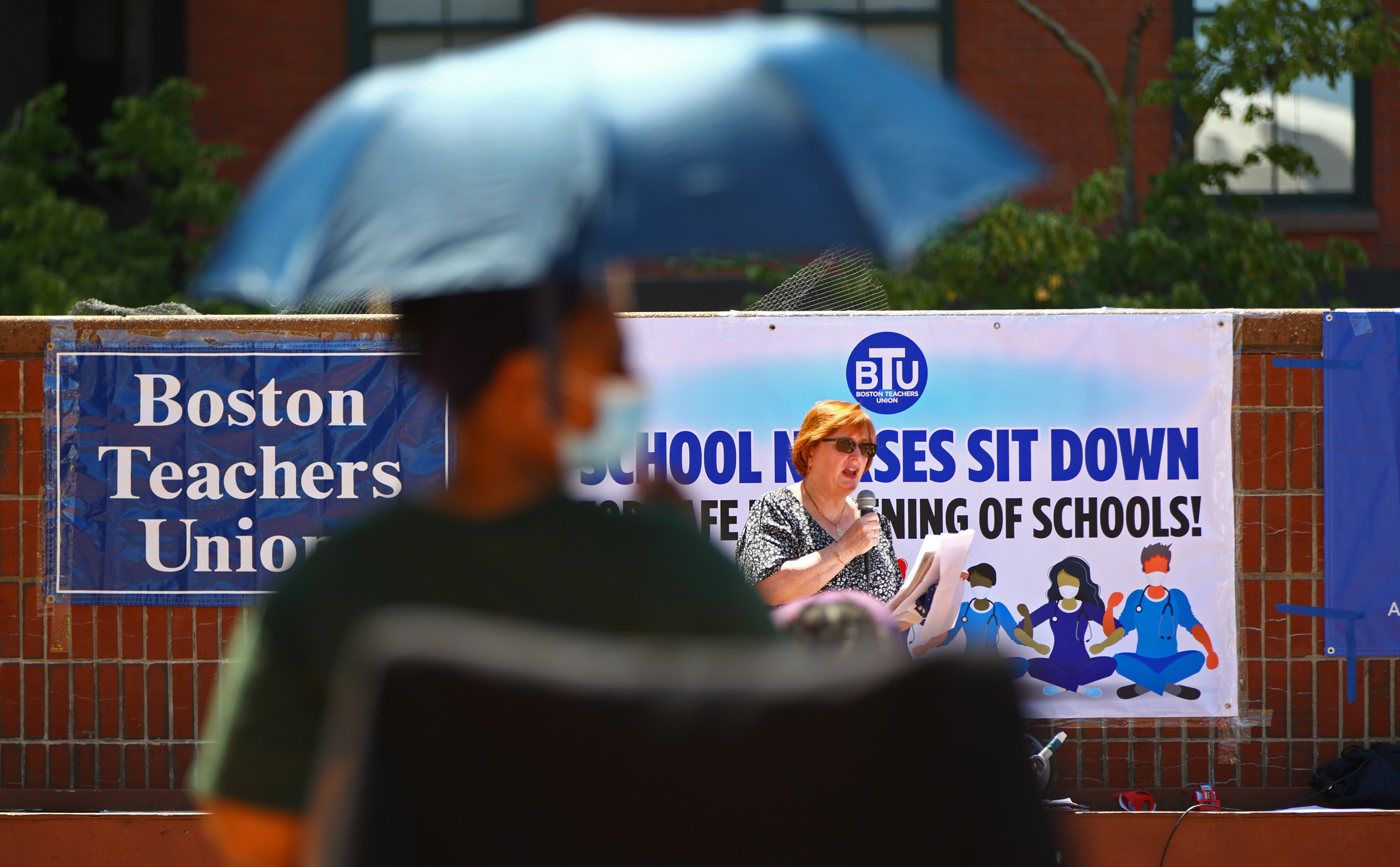 Ellen MacInnis, a board member of the Massachusetts Nurses Association and a staff RN at St. Elizabeth's, spoke to the crowd at a rally by Boston Teachers Union nurses and staffers at City Hall.