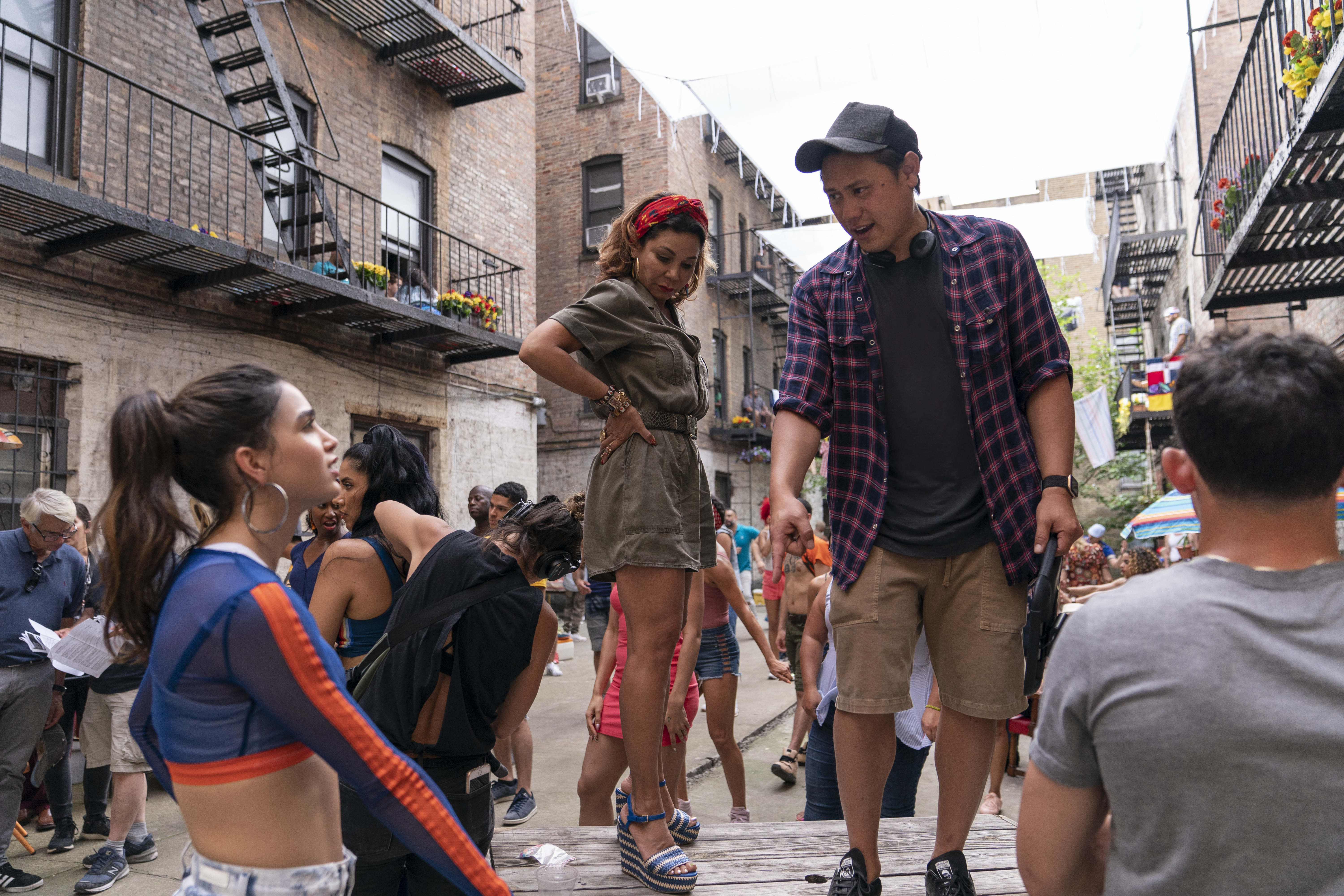 From left: Melissa Barrera, Daphne Rubin-Vega and director Jon M. Chu on the set of "In the Heights."