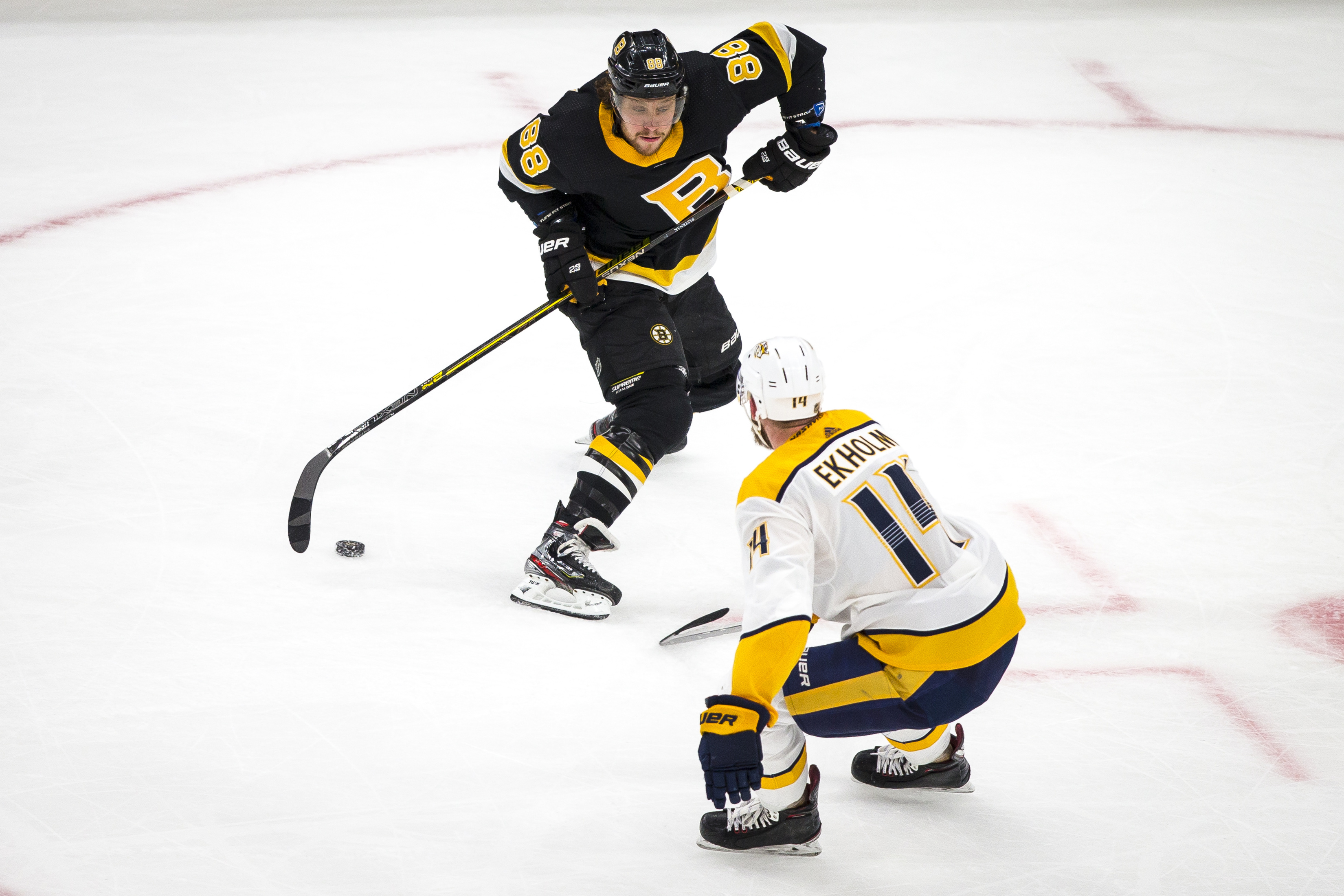 Bruins forward David Pastrnak handled the puck while being covered by Nashville Predators defenseman Mattias Ekholm in the first period of Nashville’s 4-3 win over the Bruins at TD Garden on Dec. 21.