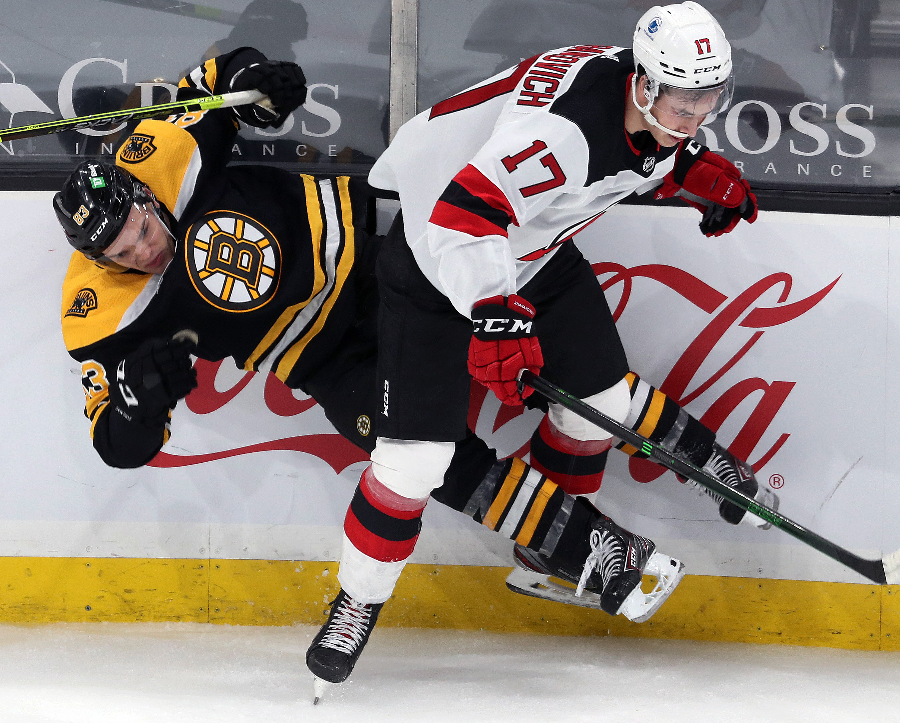 Karson Kuhlman hits the ice as he connects with New Jersey's Yegor Sharangovich in the second period of Sunday's game.