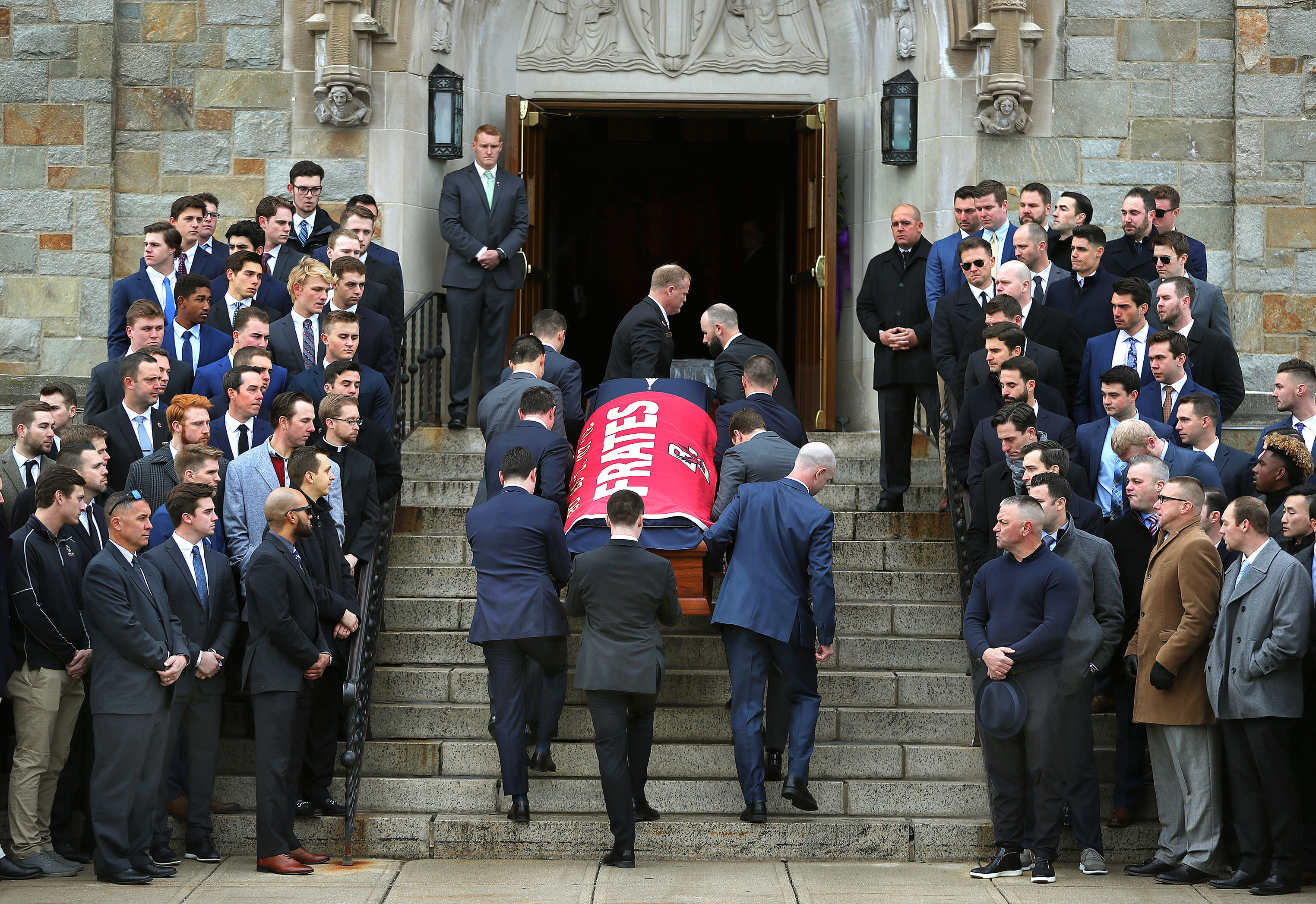 Pallbearers carried the casket of Pete Frates up the stairs at St. Ignatius Church in Boston during the funeral Mass on Dec. 13 for the former Boston College baseball star who battled ALS for years.