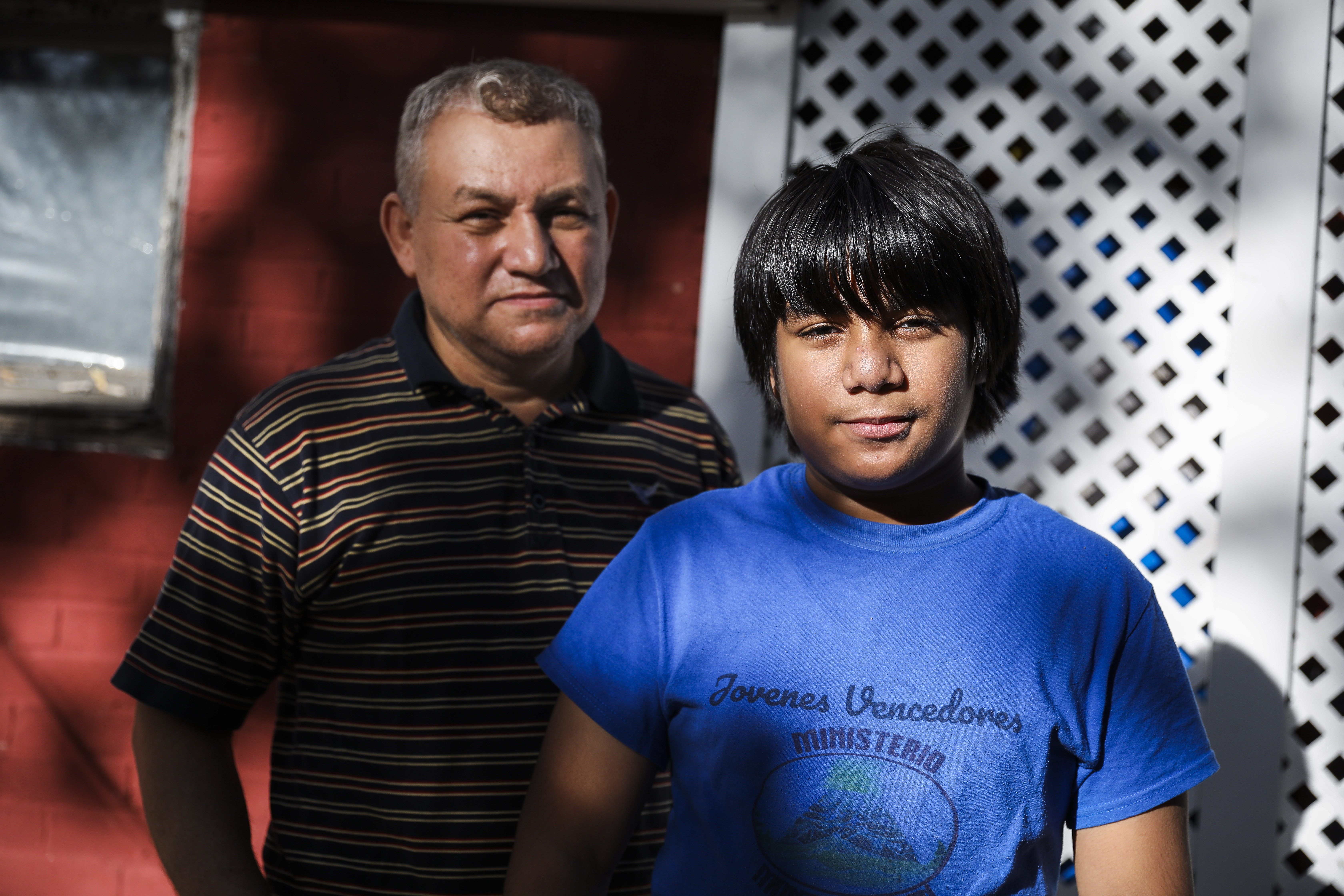 James Canelas, 10, and his father, Carlos, outside of their Chelsea home.
