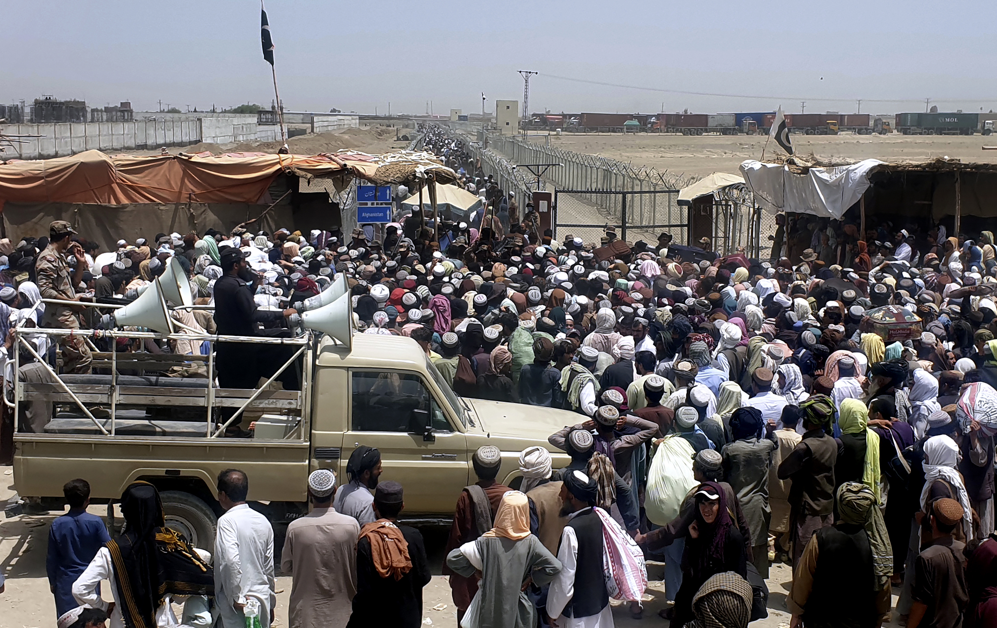 Pakistani soldiers stood guard as people waited at an Afghan border crossing point in Chaman, Pakistan.