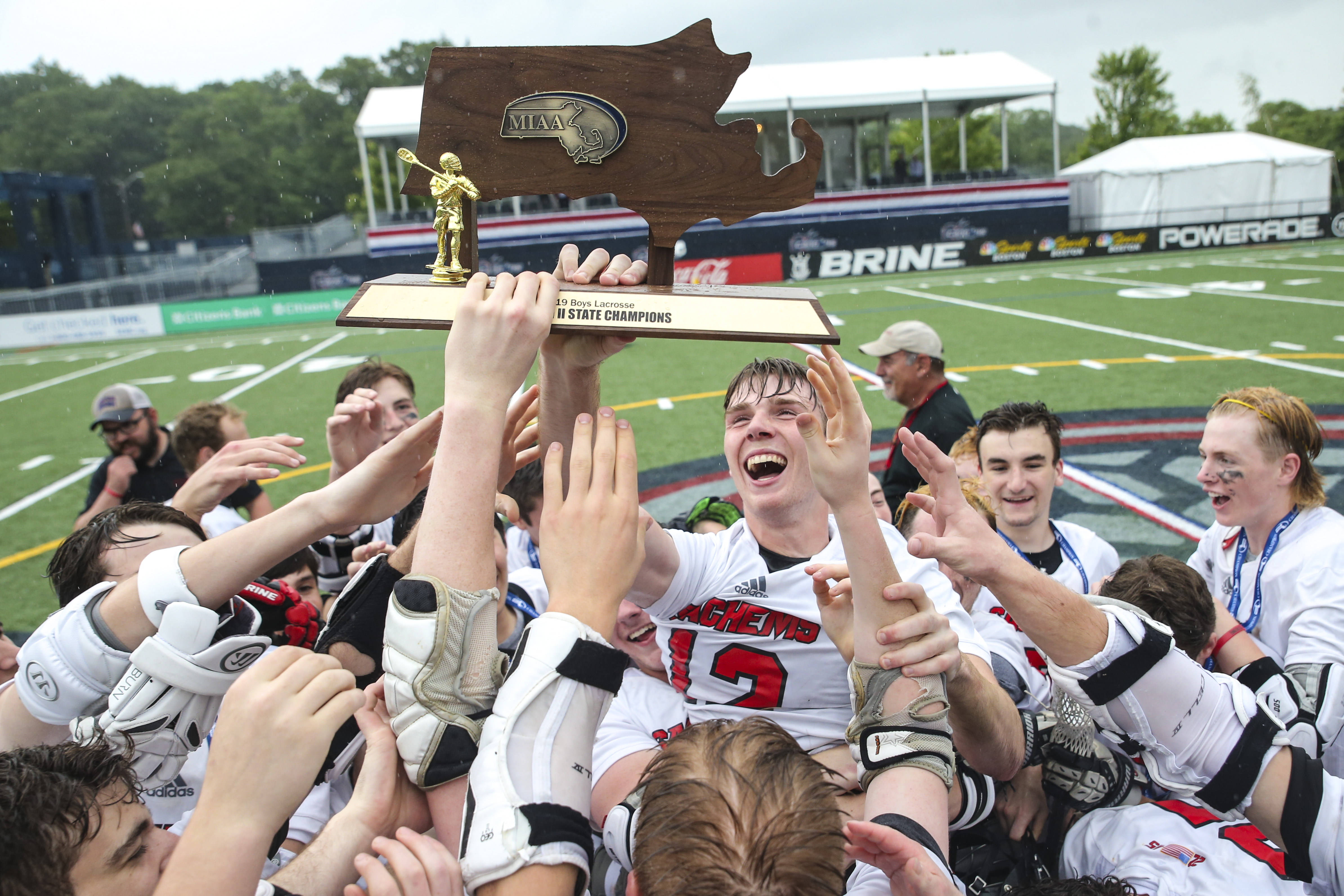 The Winchester boys’ lacrosse team celebrated with their trophy after Medfield 11-10 in the Division 2 boys’ lacross final in Quincy on June 21.