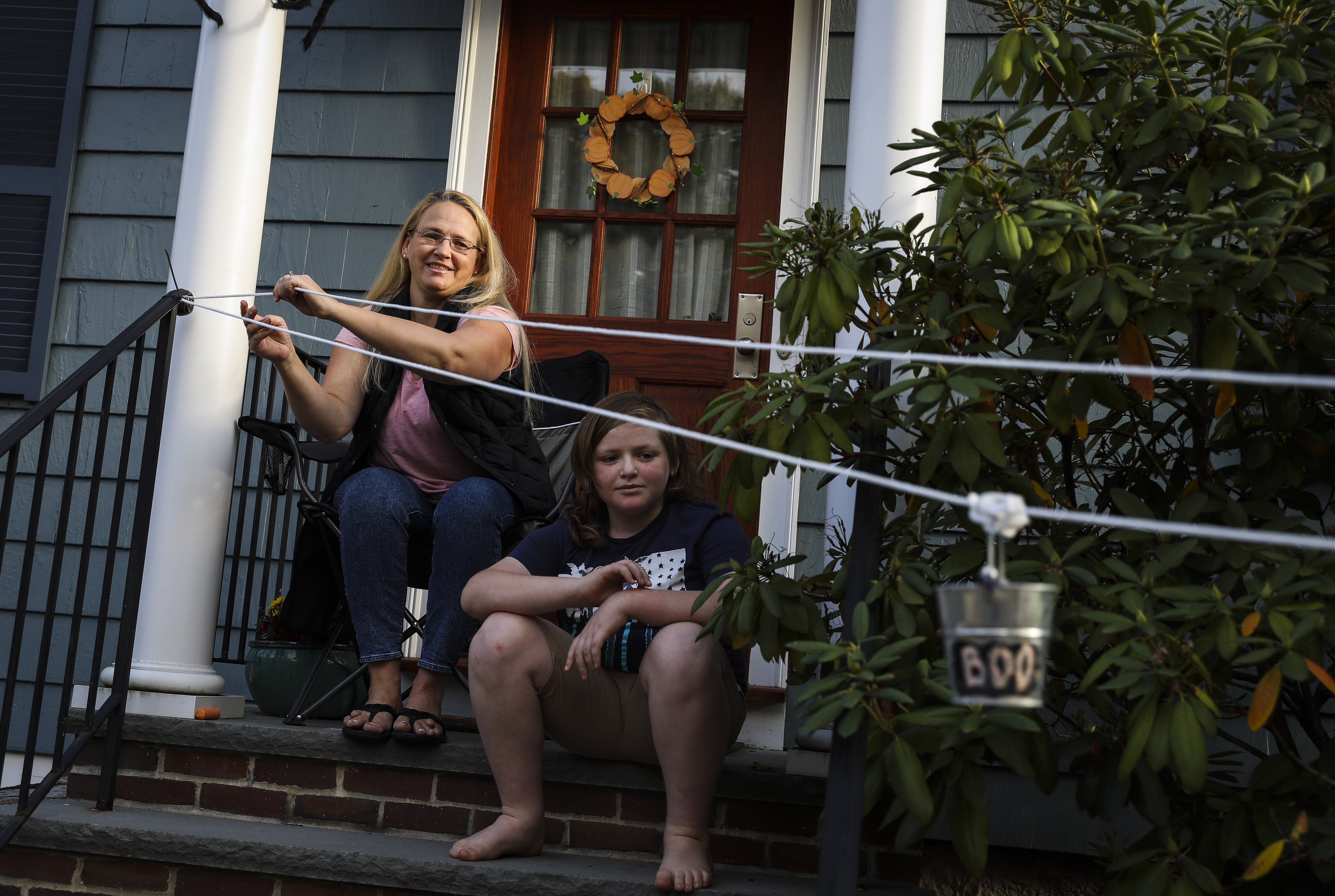 Courtney Zwirn and her 12-year-old son, Daniel, demonstrated their candy pulley system outside of their house in Arlington.