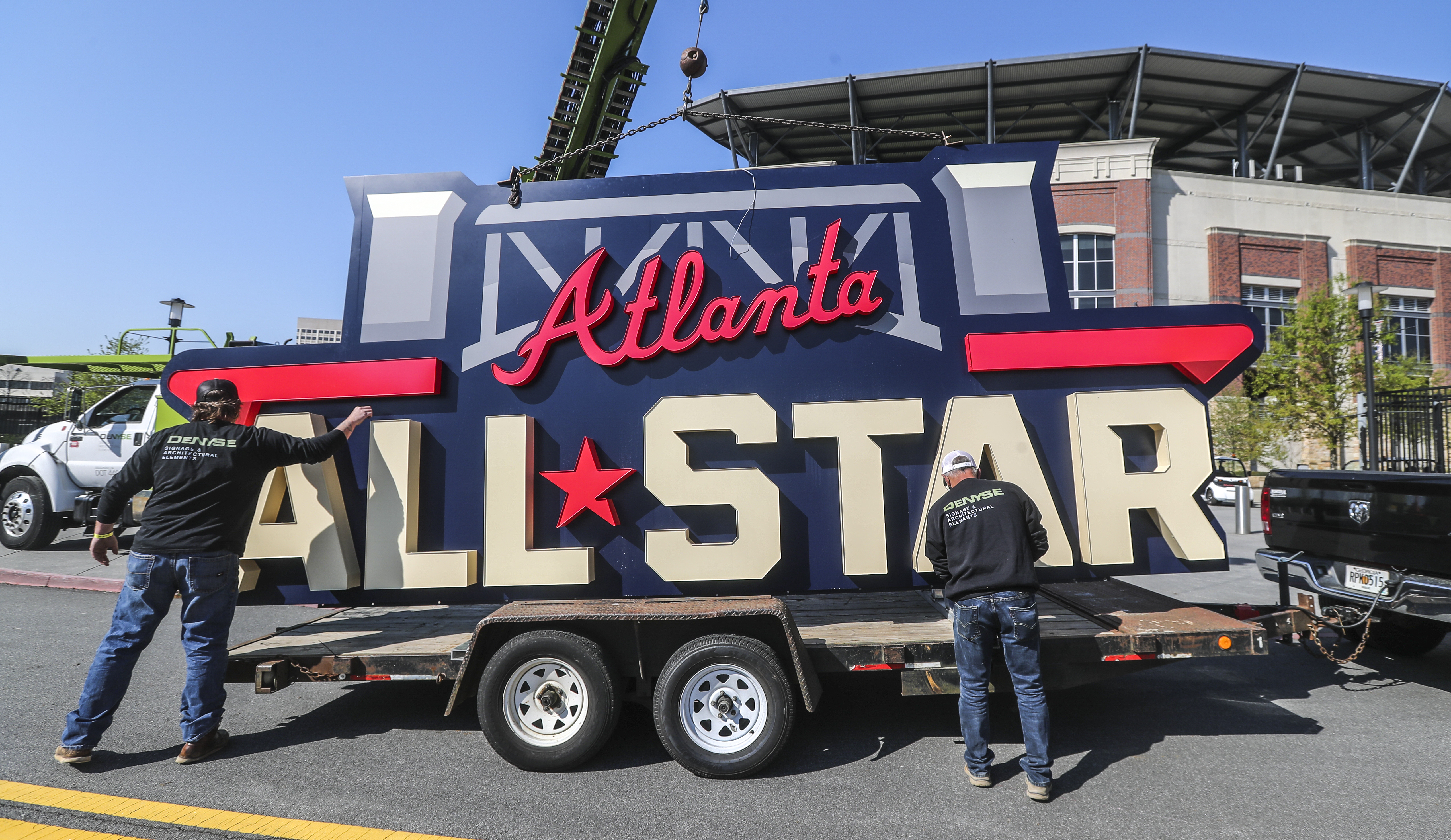 Workers load an All-Star sign onto a trailer after it was removed from Truist Park in Atlanta on Tuesday.