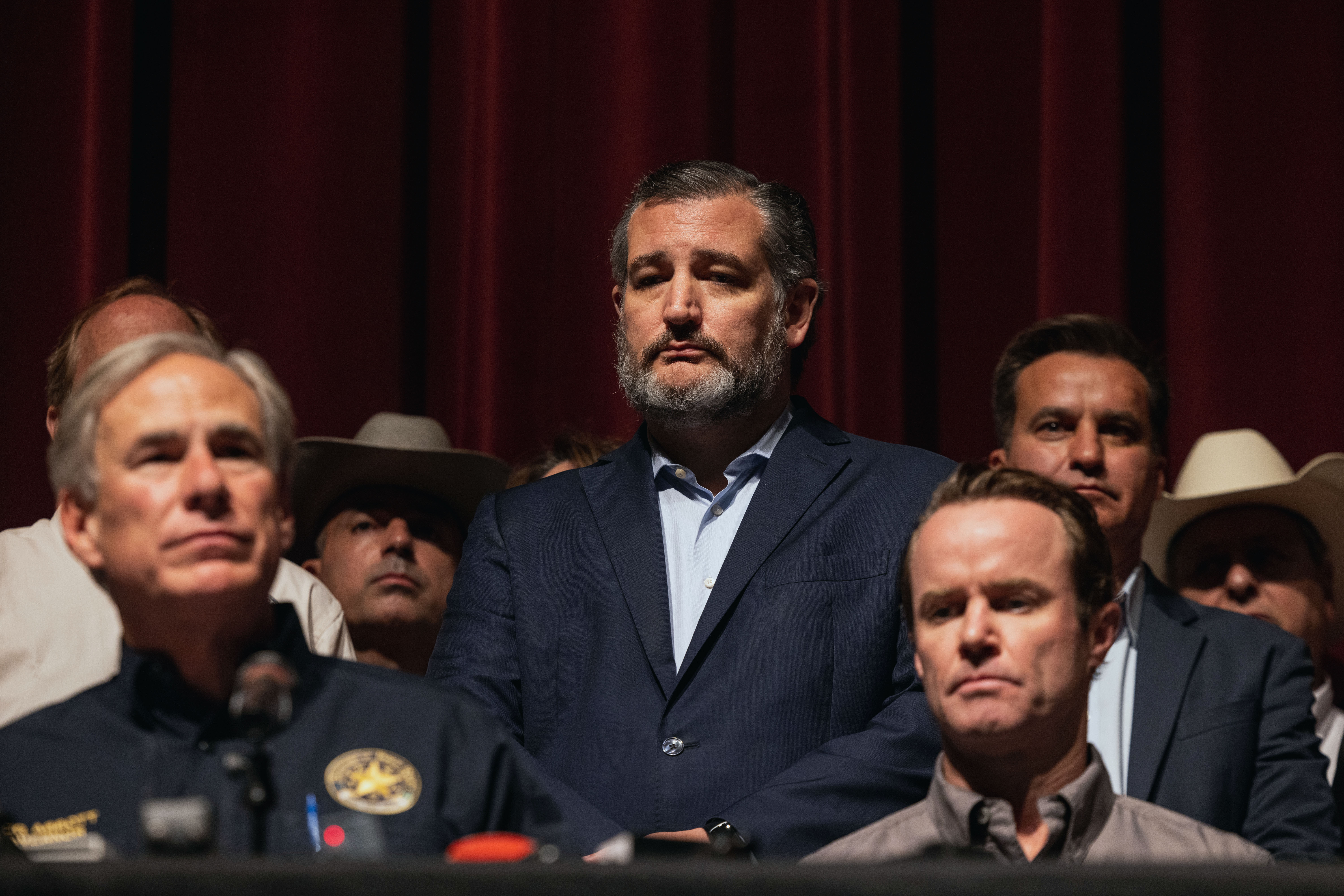 Senator Ted Cruz (R-TX) looked on as Texas Governor Greg Abbott spoke during a press conference at Uvalde High School on May 25, 2022 in Uvalde, Texas.