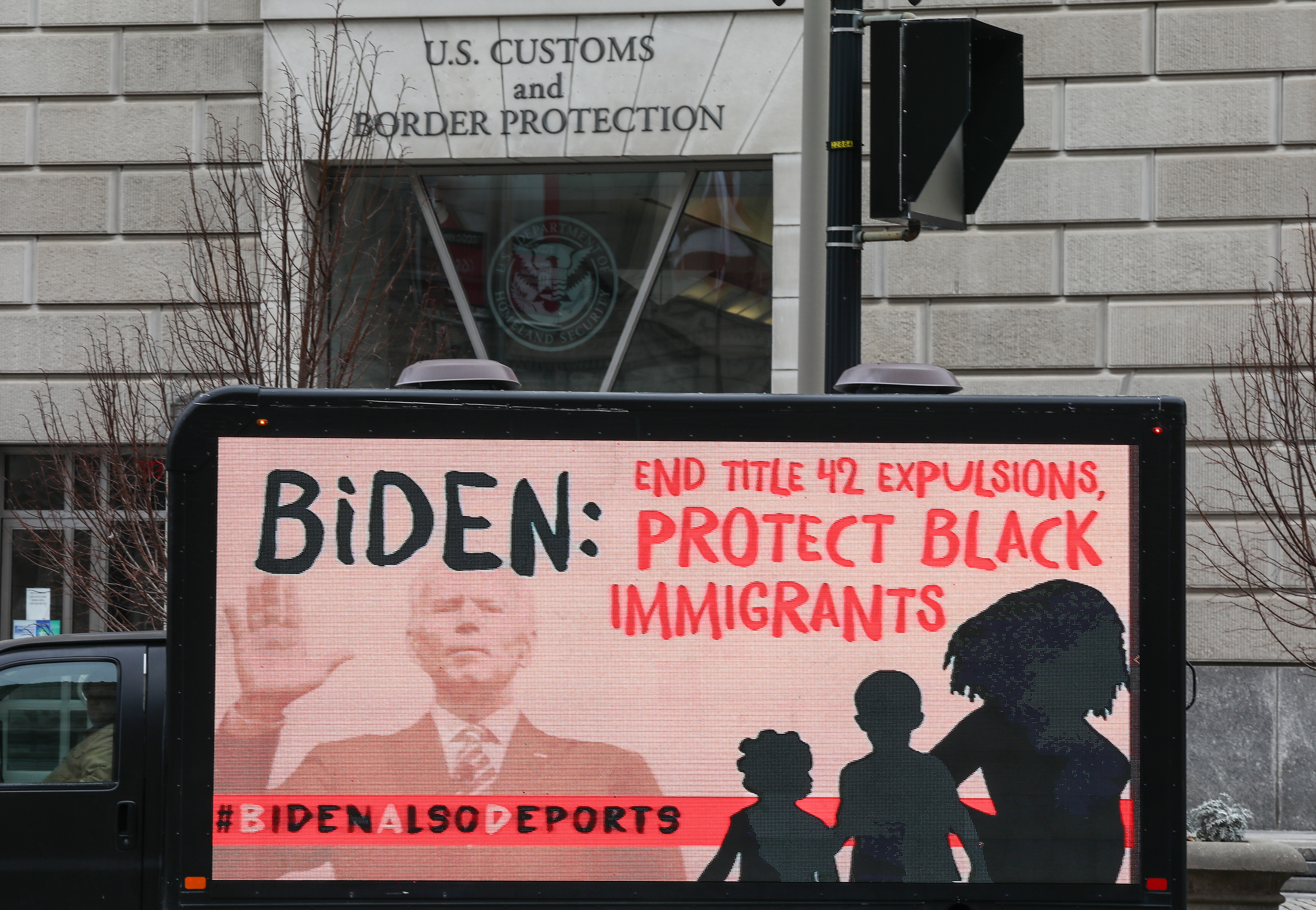 A truck with the message about the continuing mass deportations of Black immigrants drives past the office of US Customs and Border Protection prior to a #BidenAlsoDeports rally last week in Washington, D.C. The rally was held to raise the alarm over continued mass deportations of Black immigrants. JEMAL COUNTESS/GETTY IMAGES