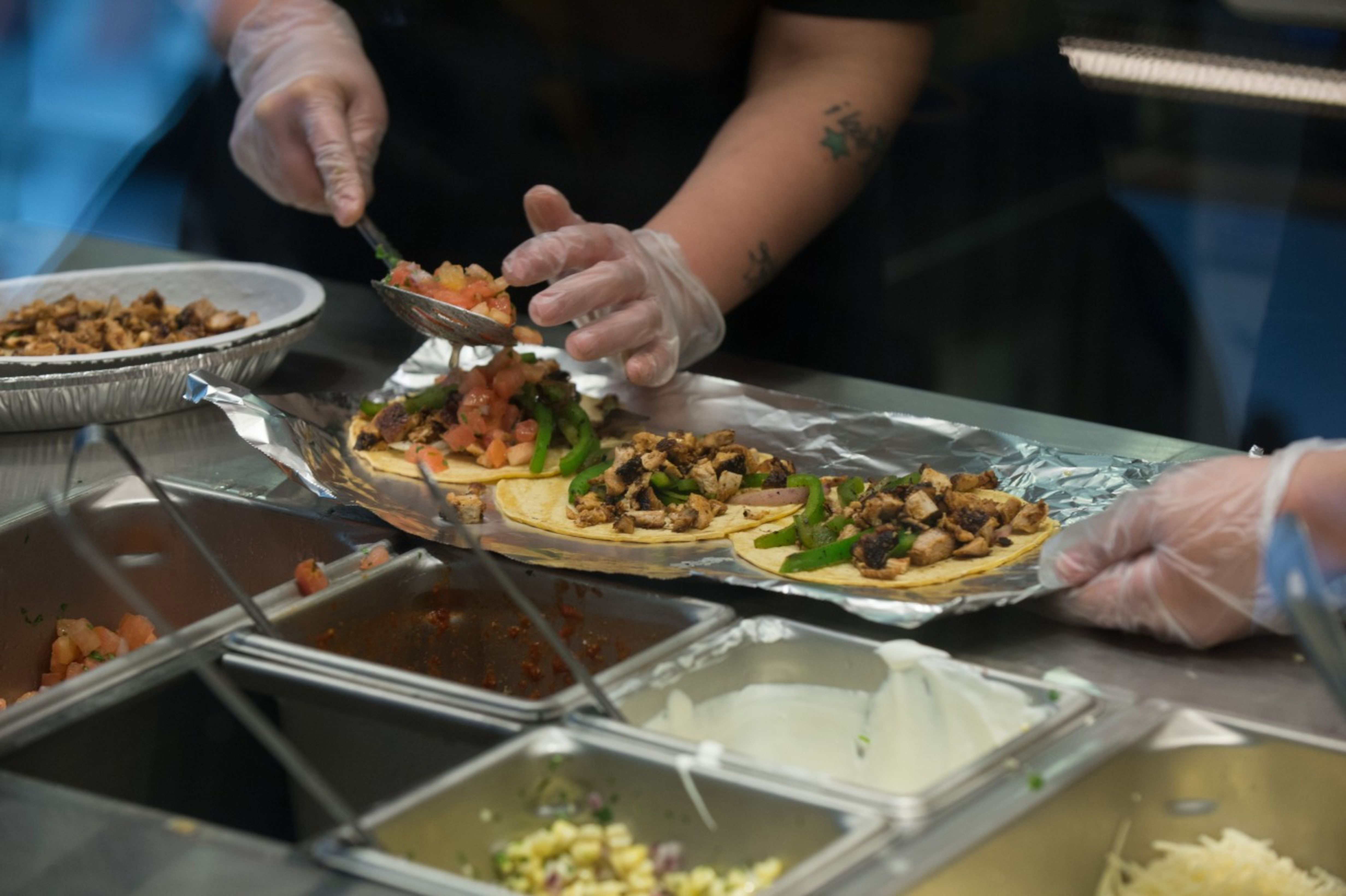 Employees prepared lunch orders at a Chipotle Mexican Grill in New York.