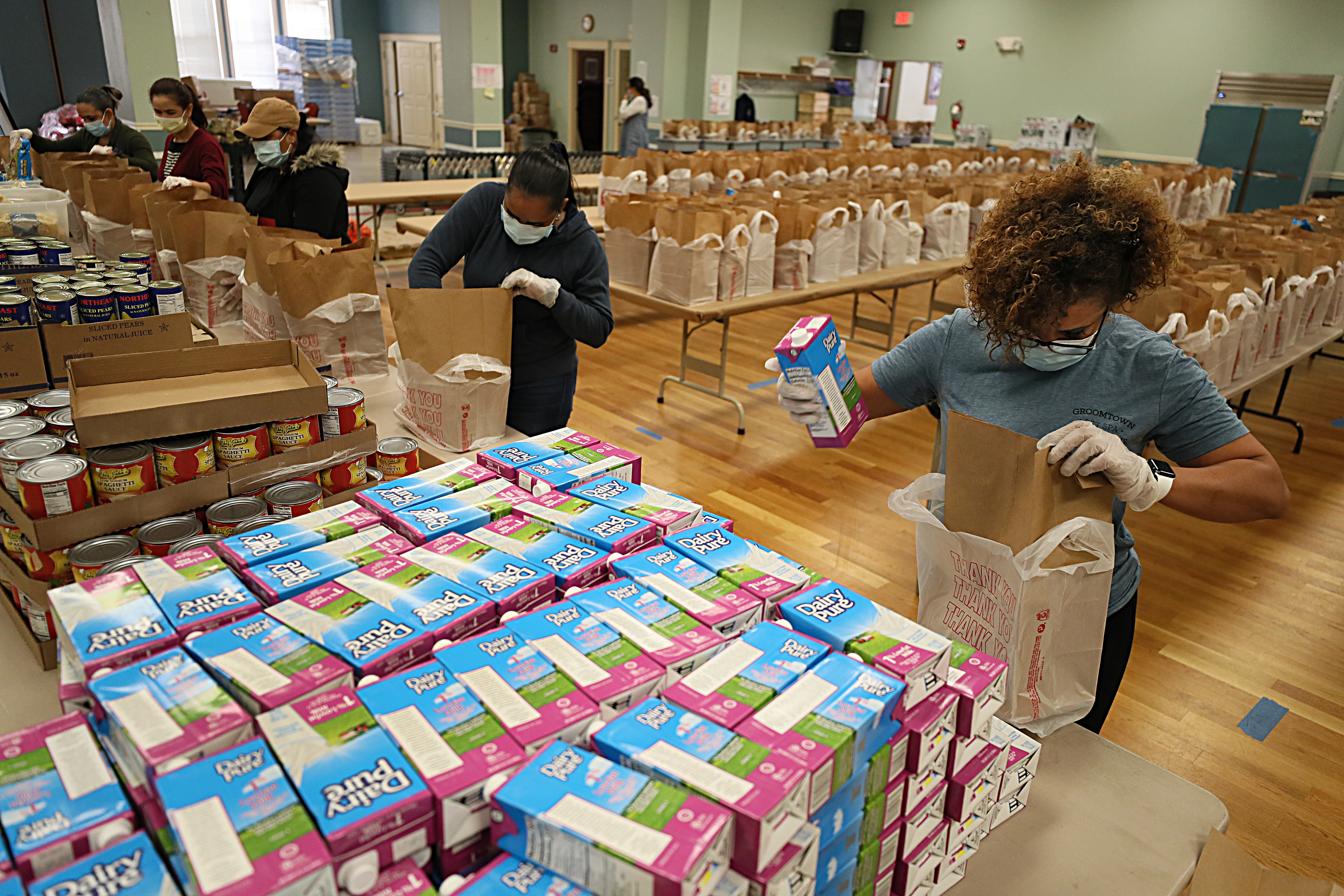 Staff at the Lawrence Senior Center prepare meals for delivery to seniors at home.