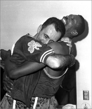 Bob Cousy and Bill Russell embrace after the end of another championship season.