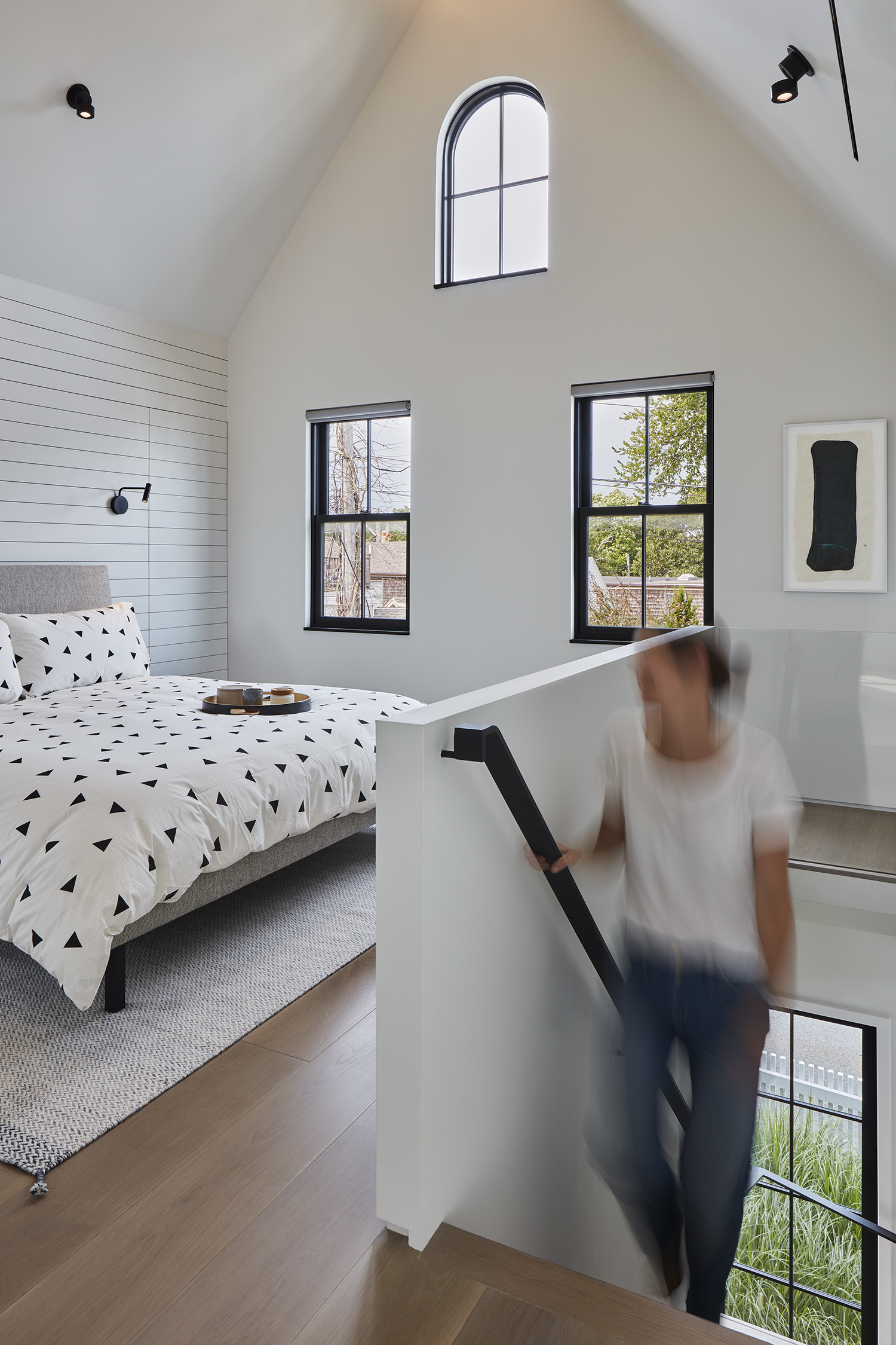The architects removed an attic bedroom and bath to create a double-height master suite. The abstract artwork by Judith Trepp comes from local gallery AMP.