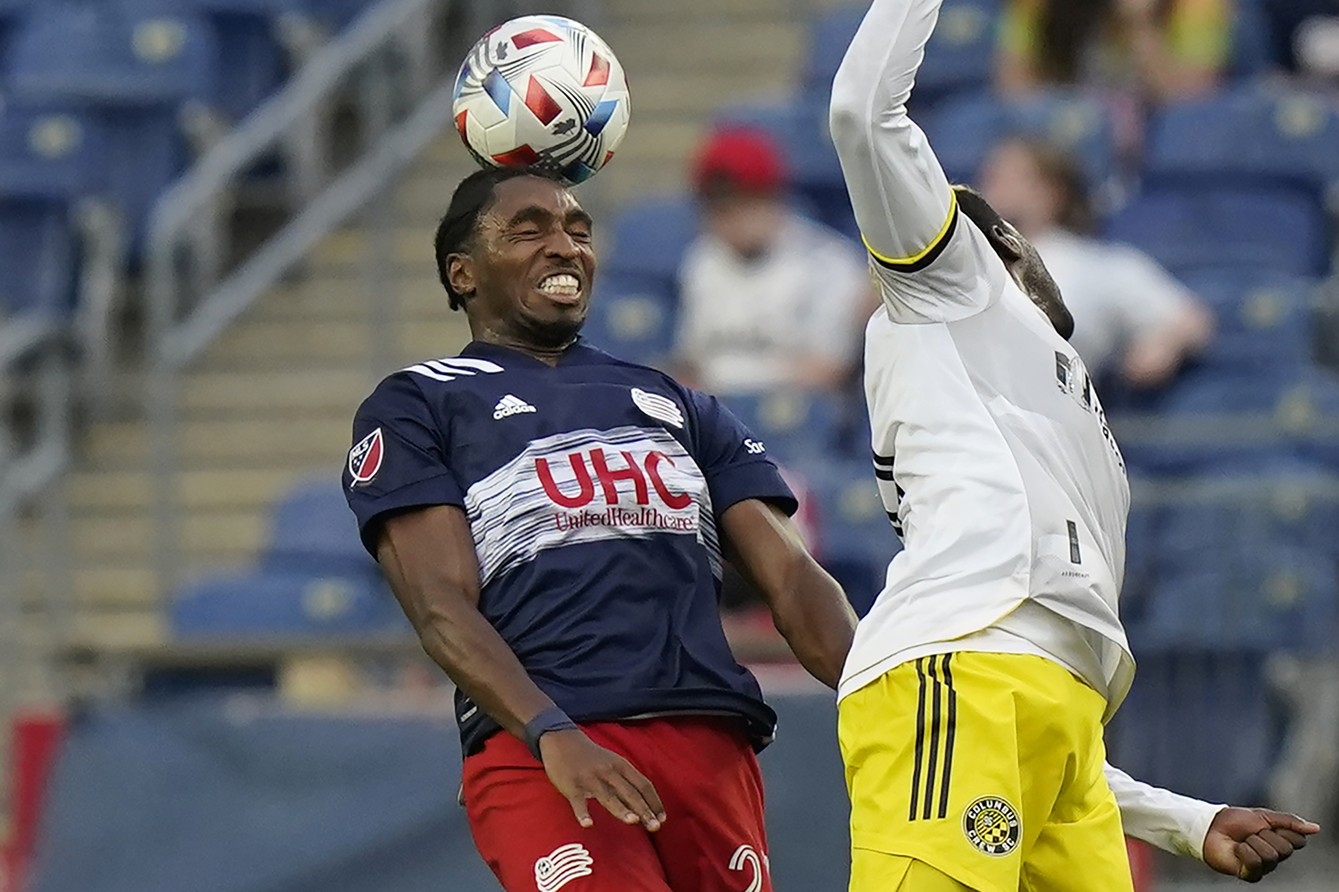 New England's Jon Bell heads the ball as Columbus' Gyasi Zerdes vies for control in first half of Sunday's game.