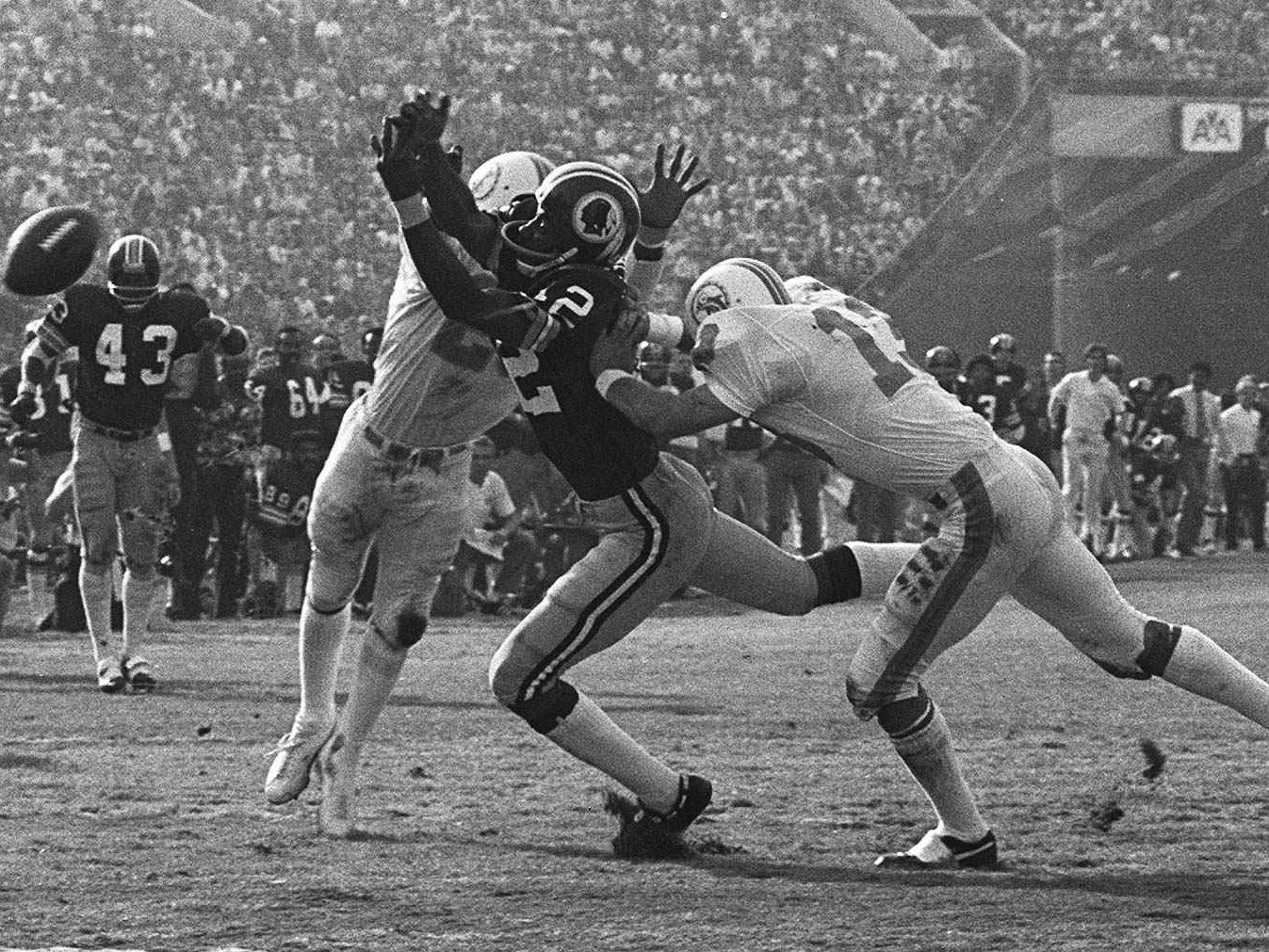 Jake Scott (right) helps break up a pass intended for Washington's Charley Taylor during Super Bowl VII.