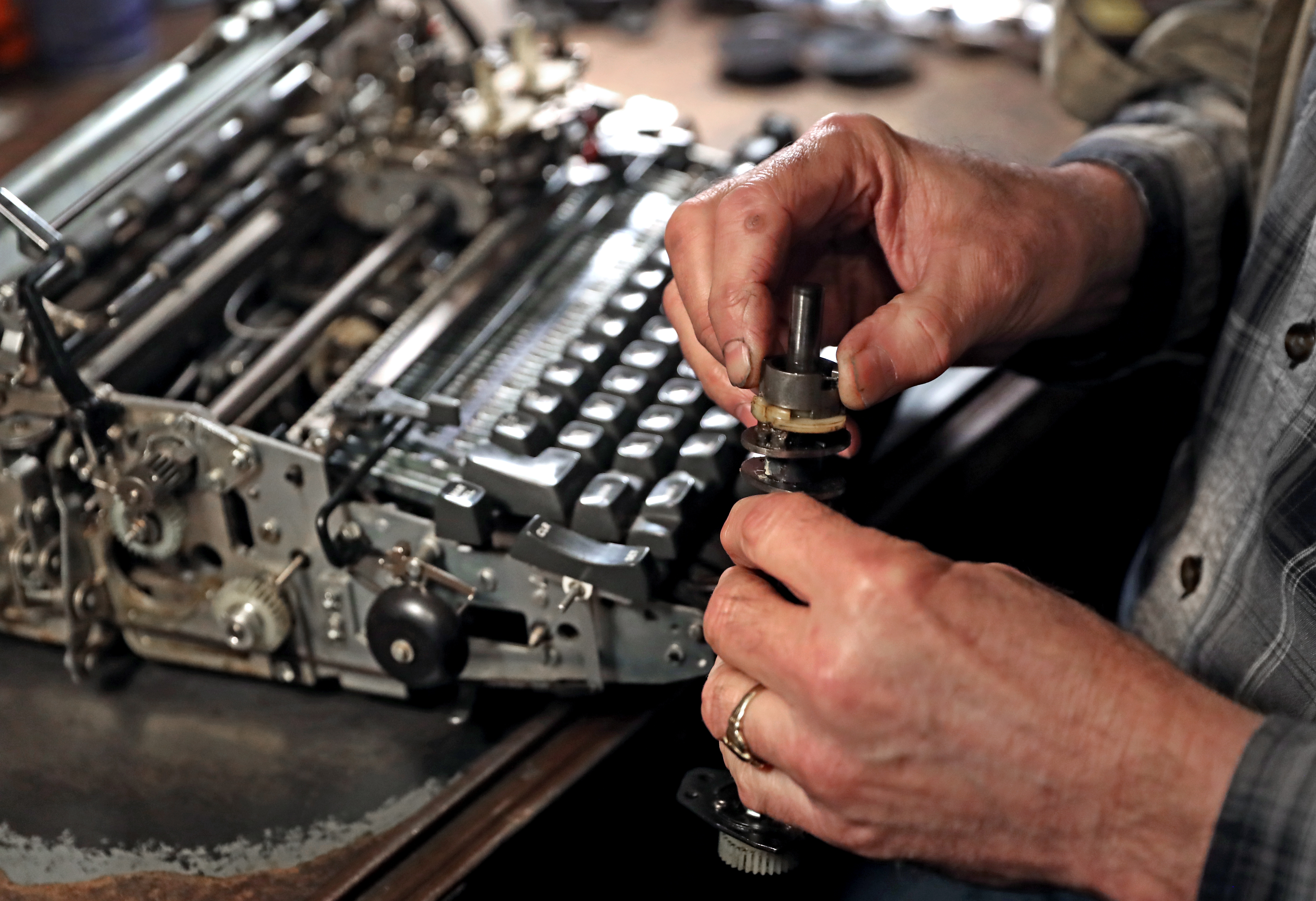 Tom Furrier repairs a typewriter.