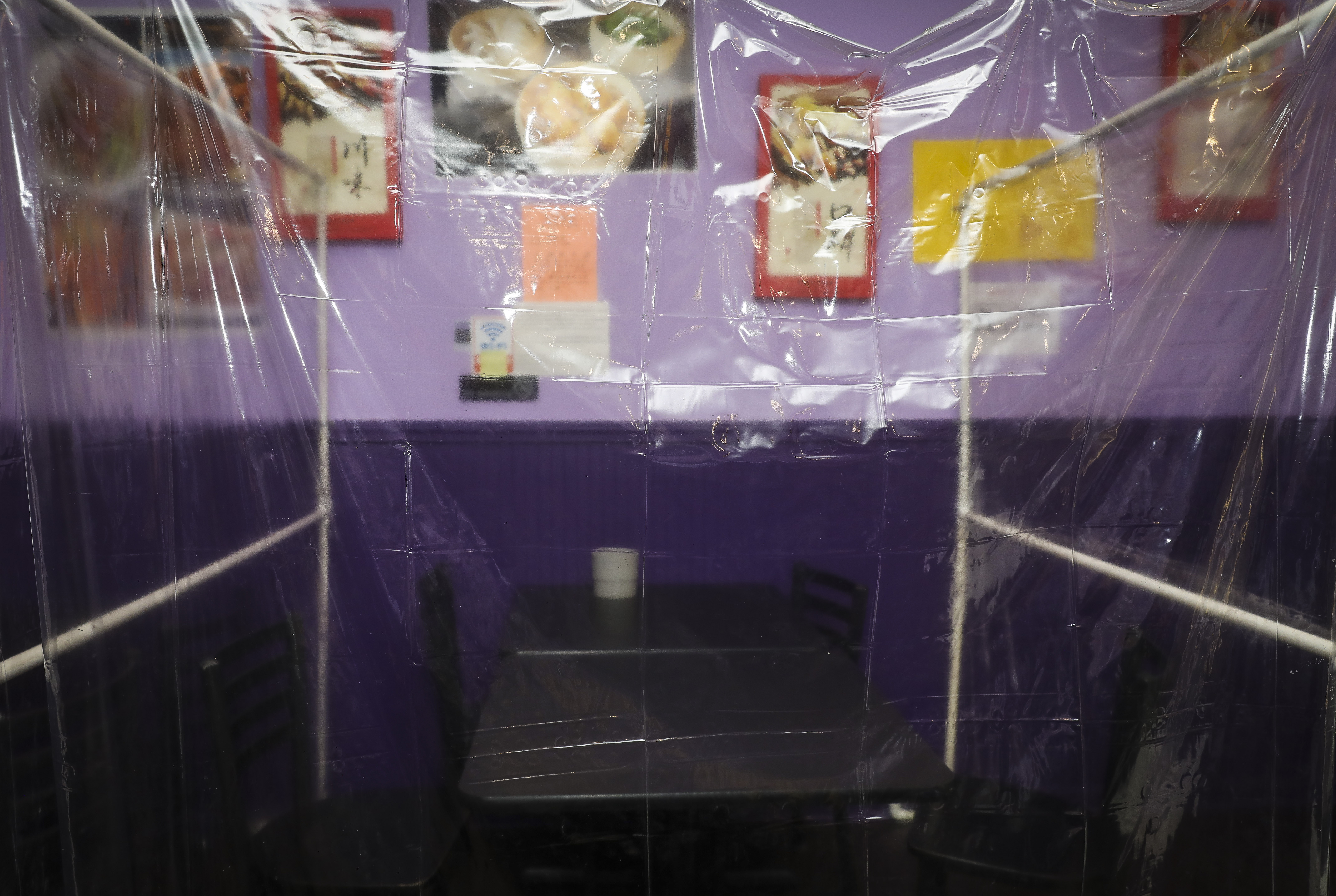 Spicy World in Chinatown has erected clear plastic partitions between tables to protect employees and customers from the spread of COVID-19.