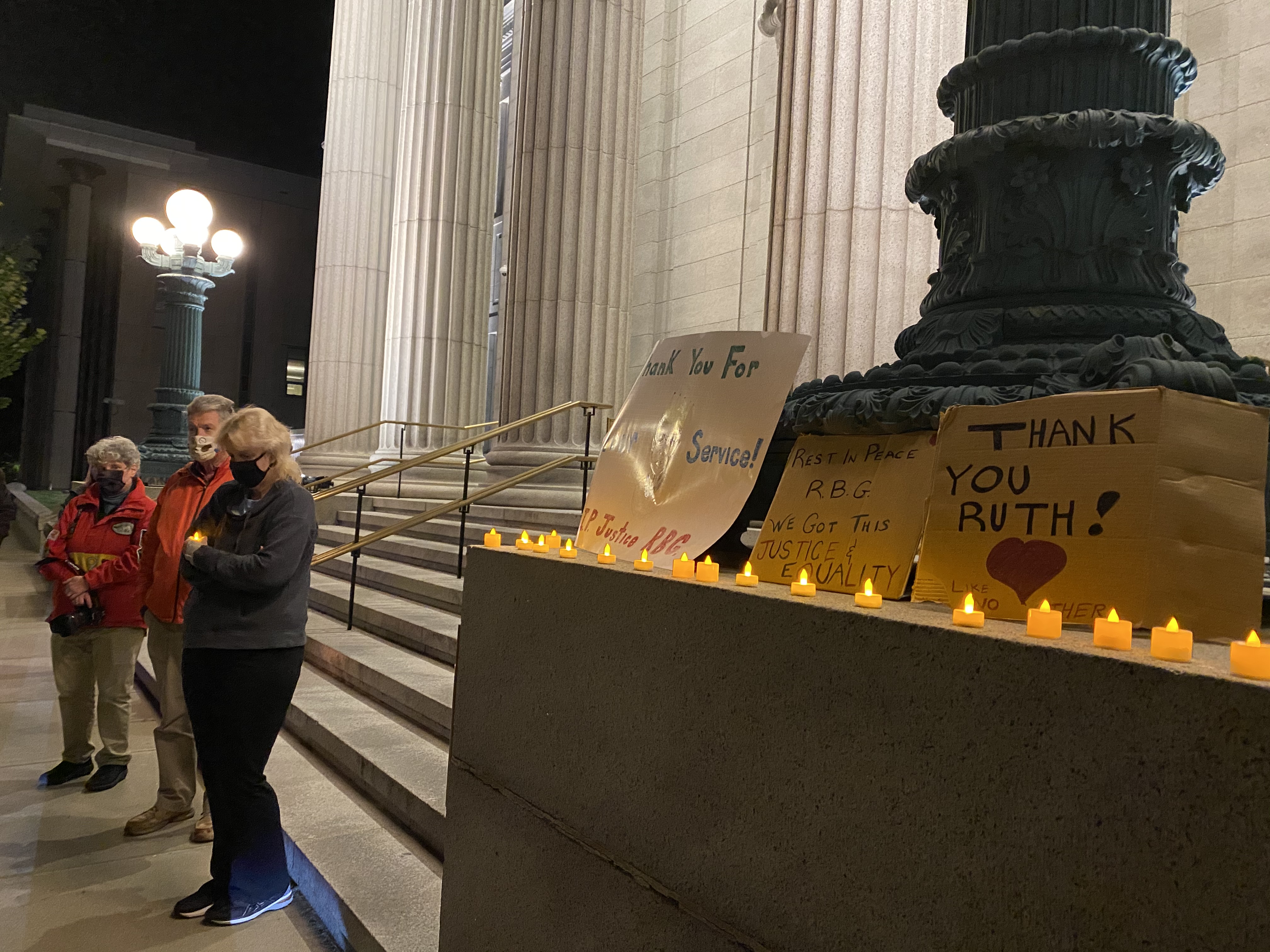 Organizers spoke at a candlelit vigil outside the the Essex Family & Probate Court in Salem.
