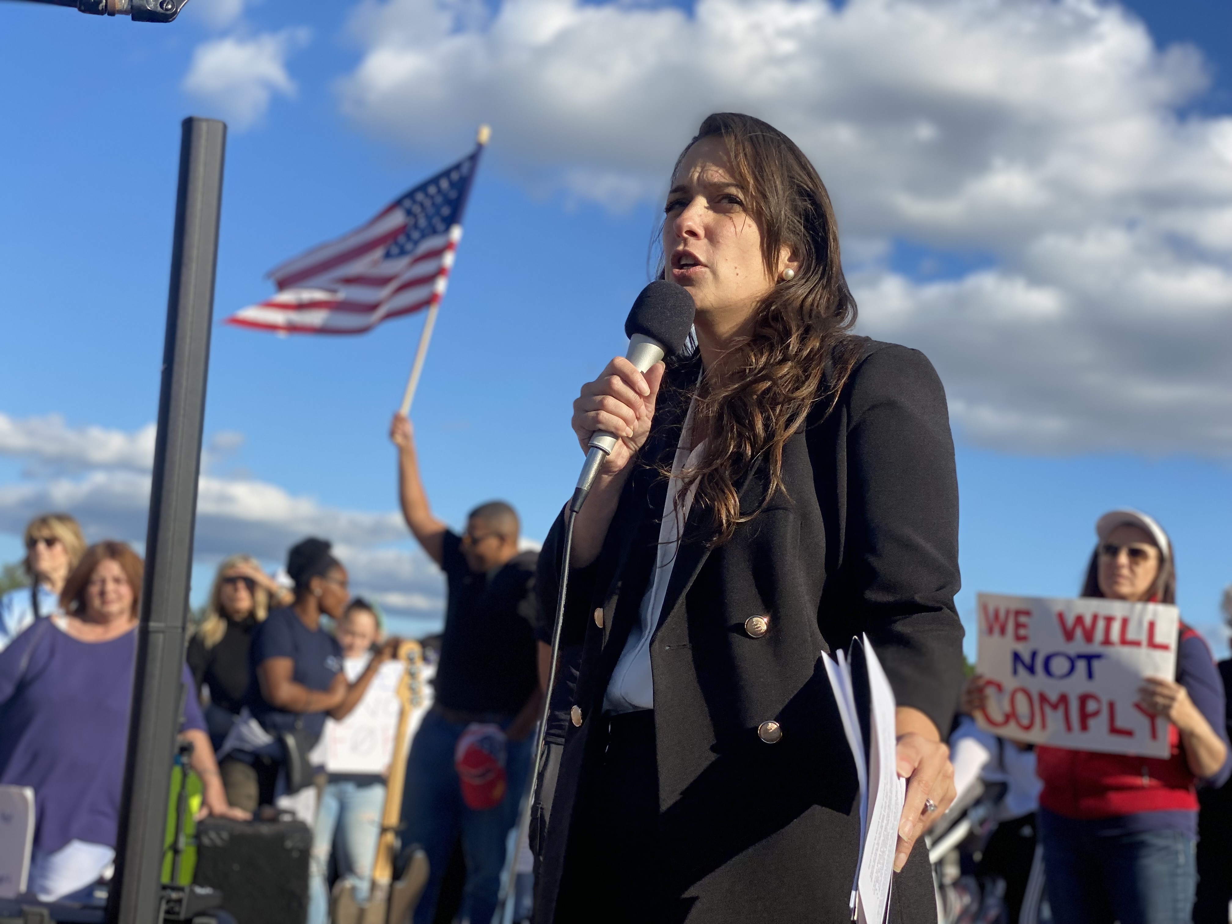 R.I. state Senator Jessica de la Cruz speaks at a rally for health care workers who are protesting the state's COVID-19 vaccine mandate on Oct. 1, 2021, in Providence.