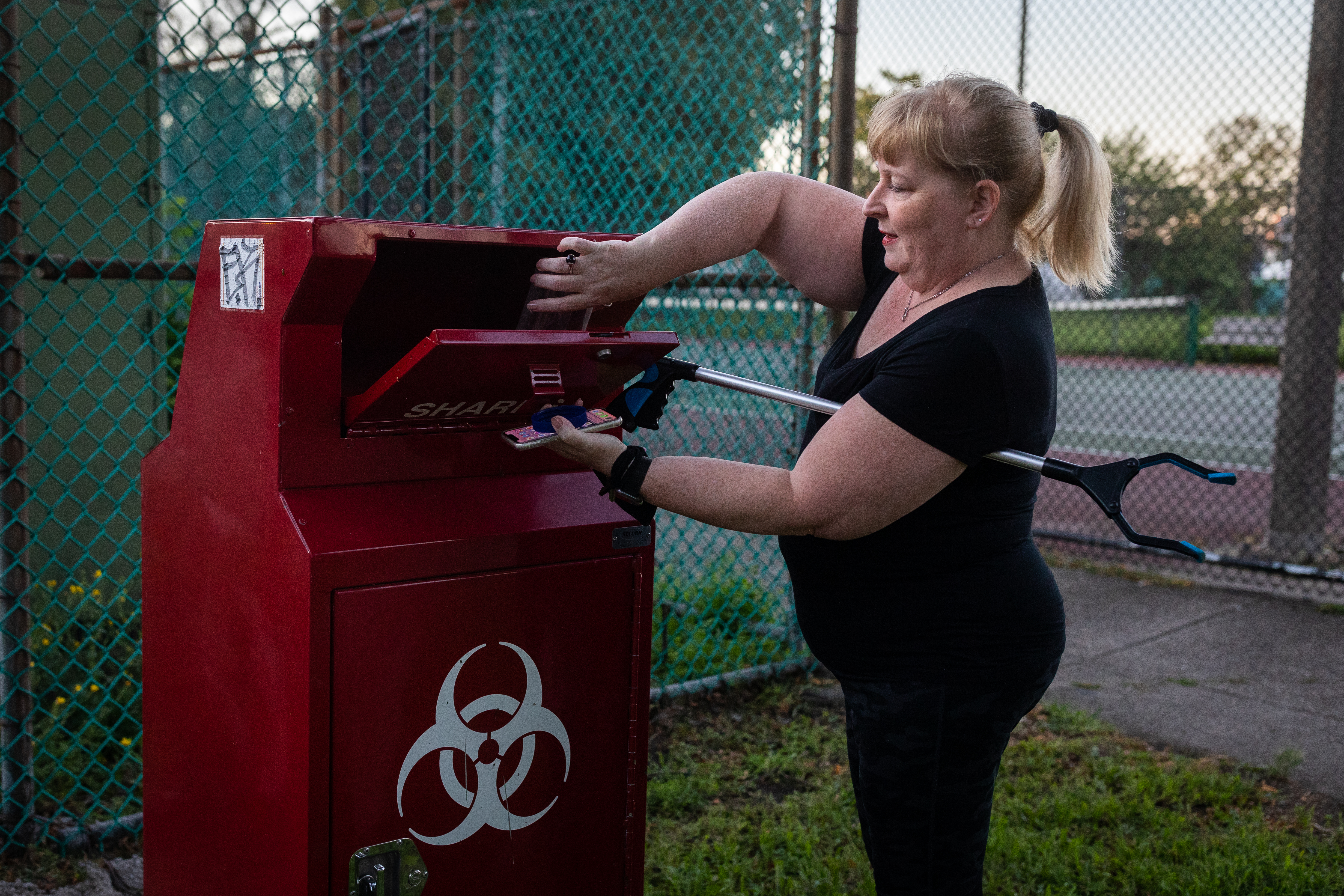 Marla Smith, a community member who has been in the neighborhood for 28 years, disposed dirty needles in a sharps bin at Clifford Park on Sept. 3.