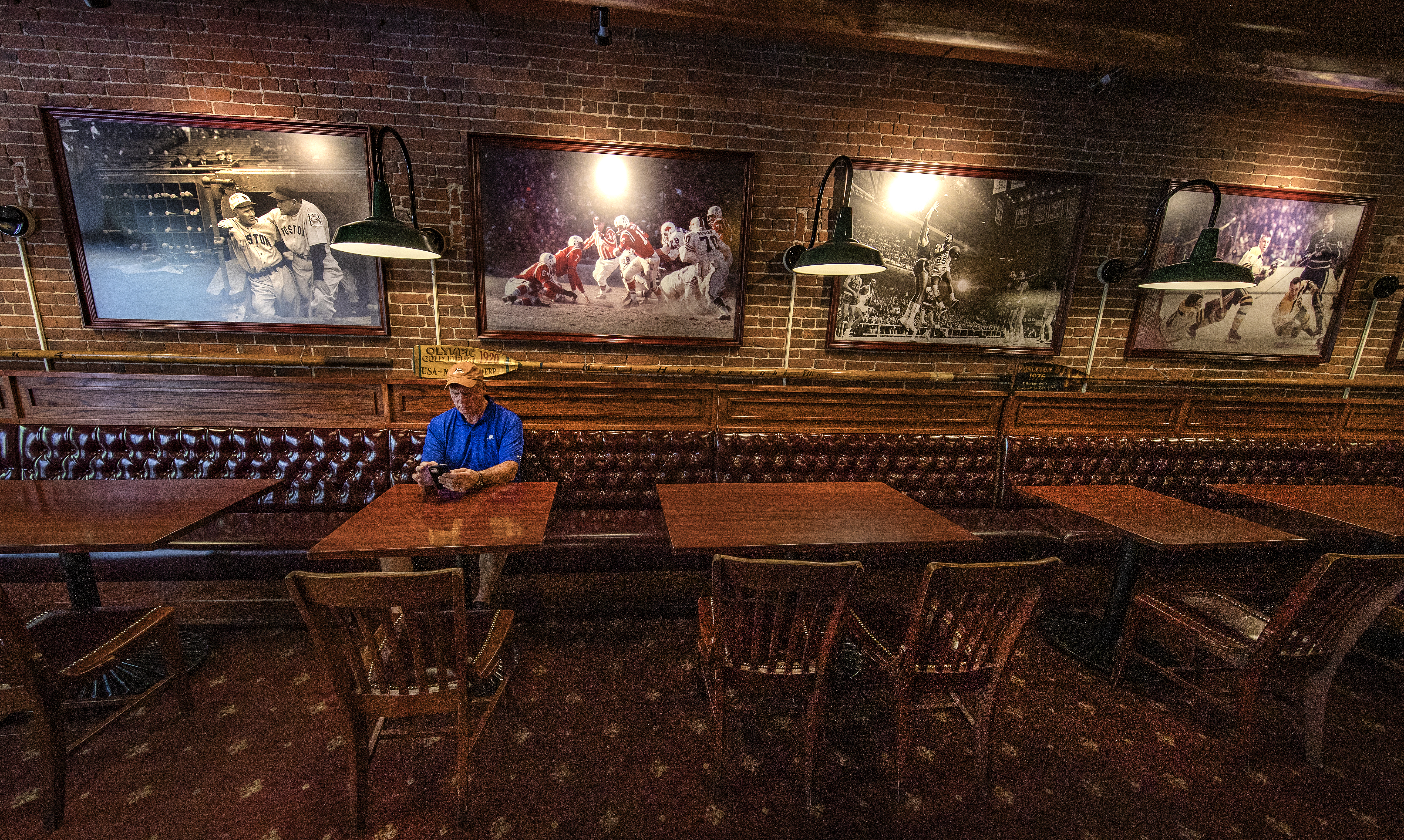 Peter Colton sits in an empty dining room at The Fours on Canal Street. Management announced Aug. 31 that the bar would close because of the pandemic.