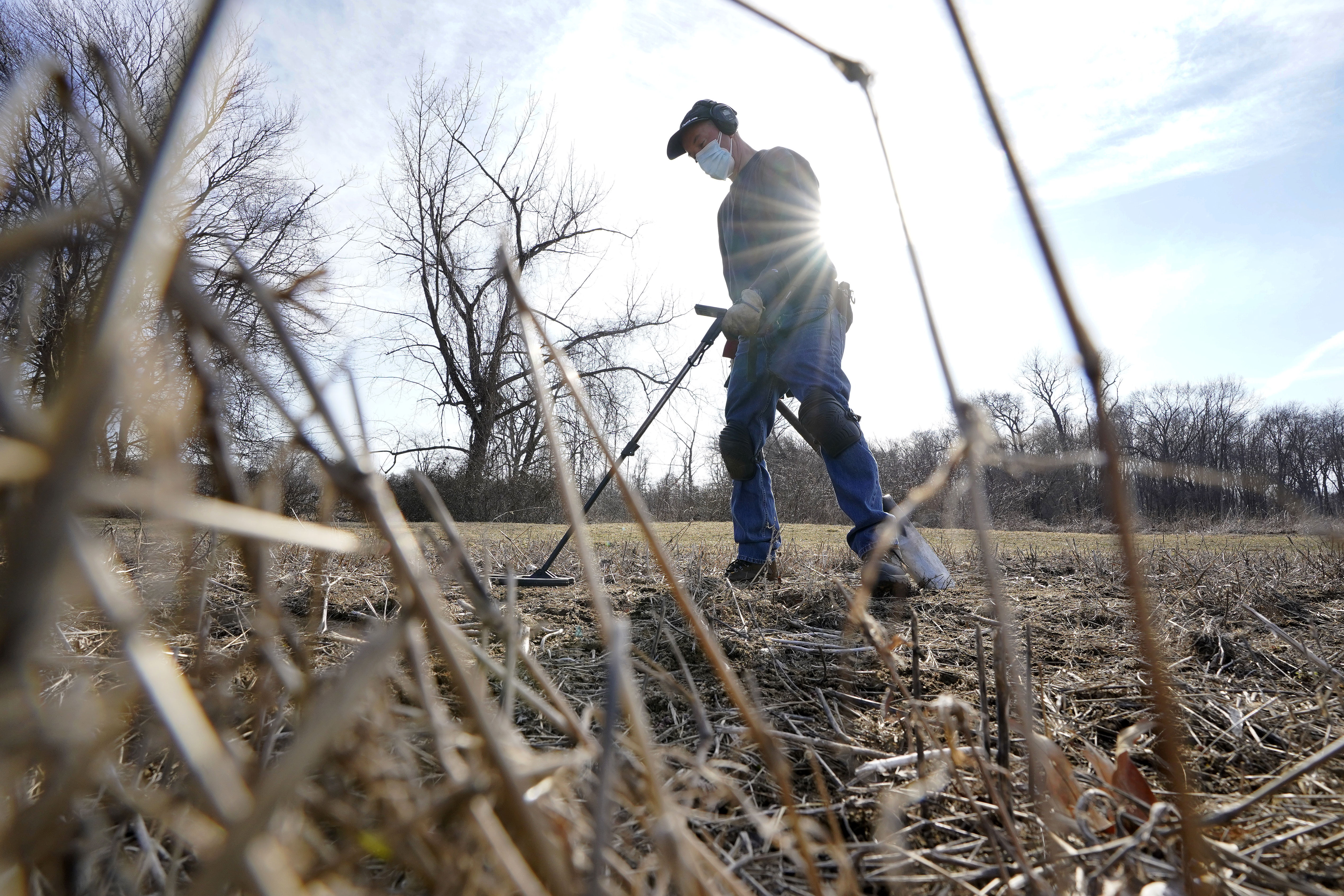 Amateur historian Jim Bailey used a metal detector to scan for Colonial-era artifacts in a field in Warwick, R.I.