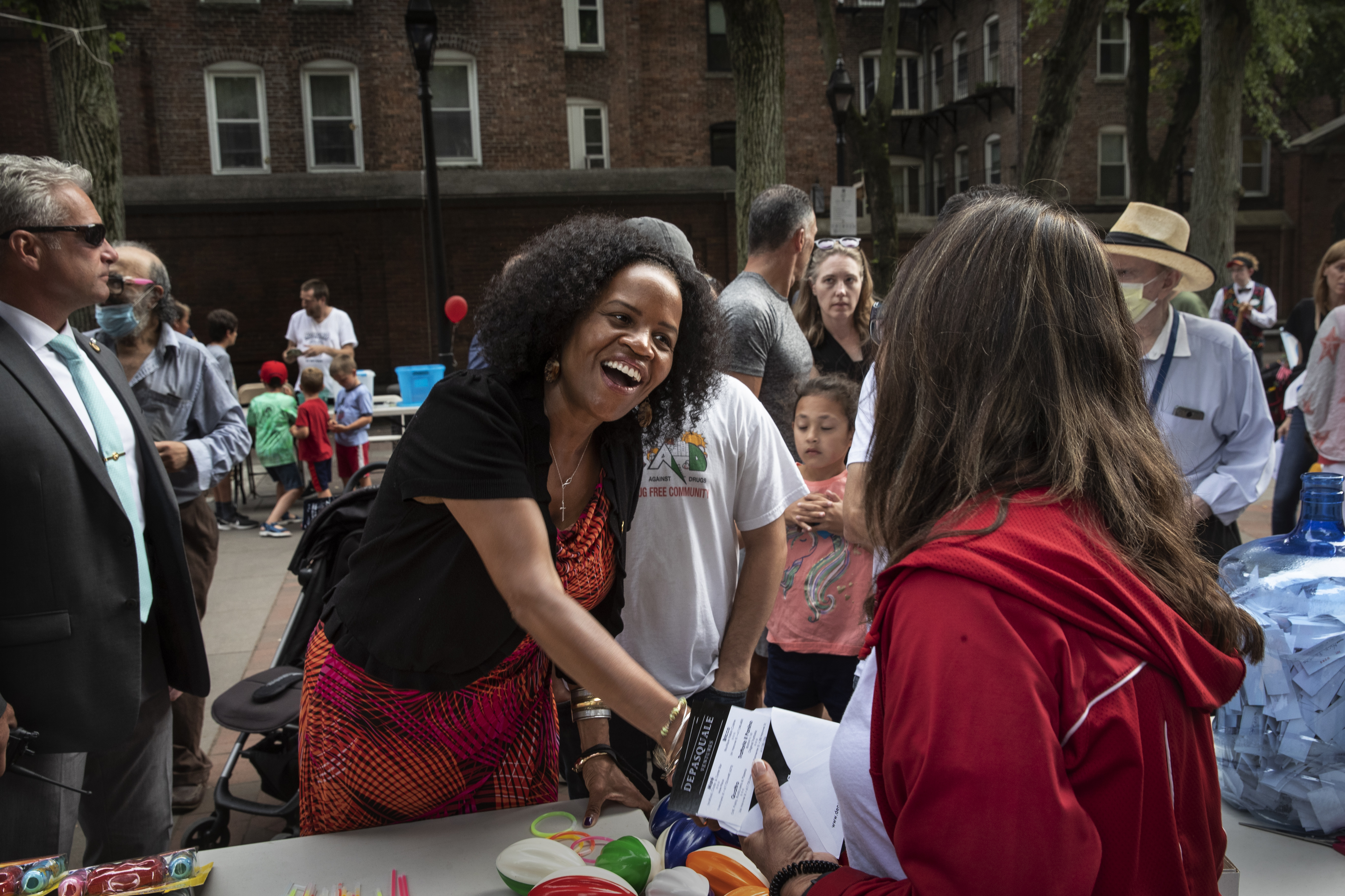 Kim Janey greets community members during a neighborhood block party in the North End neighborhood of Boston.